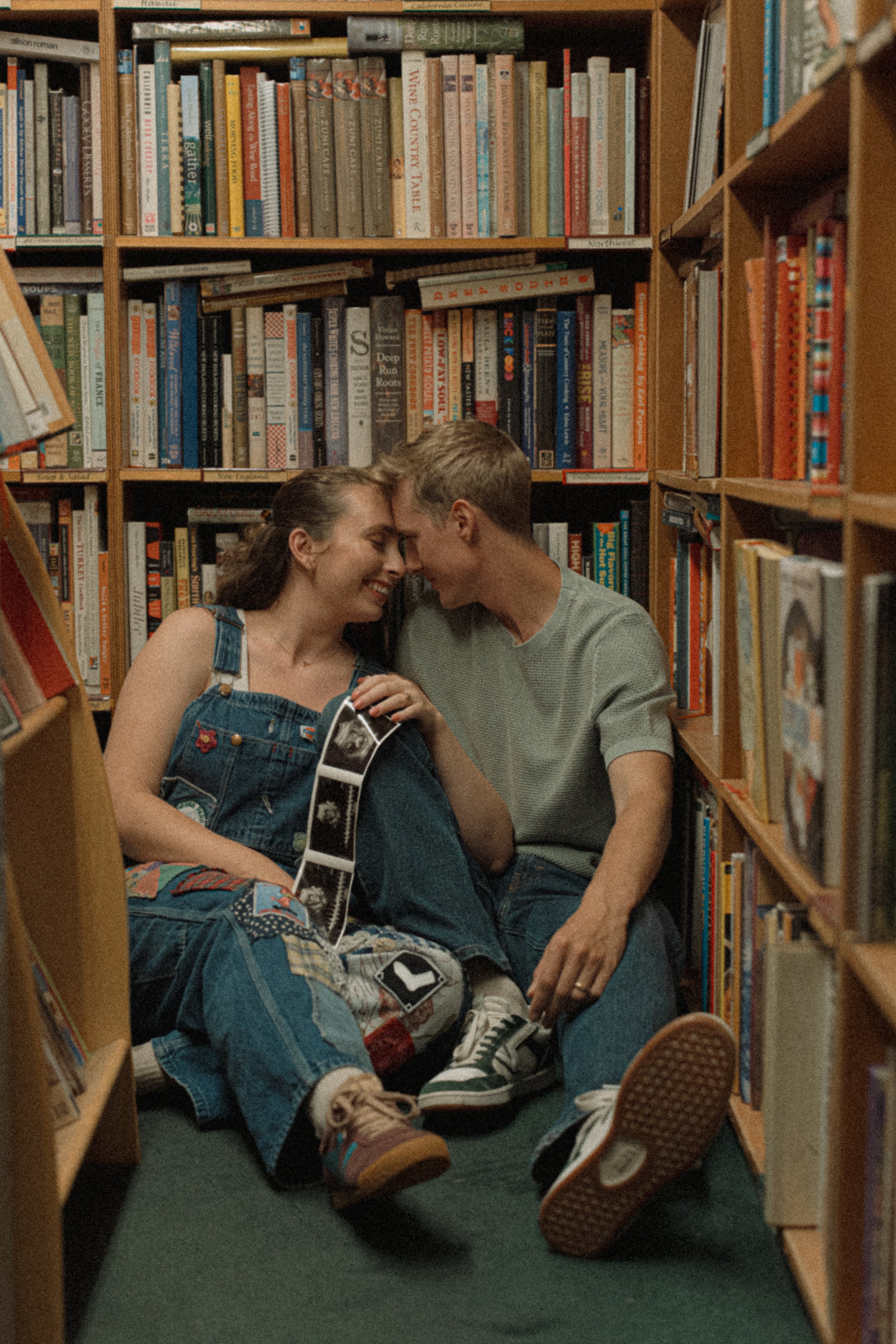 A couple having a sweet intimate moment in a bookstore