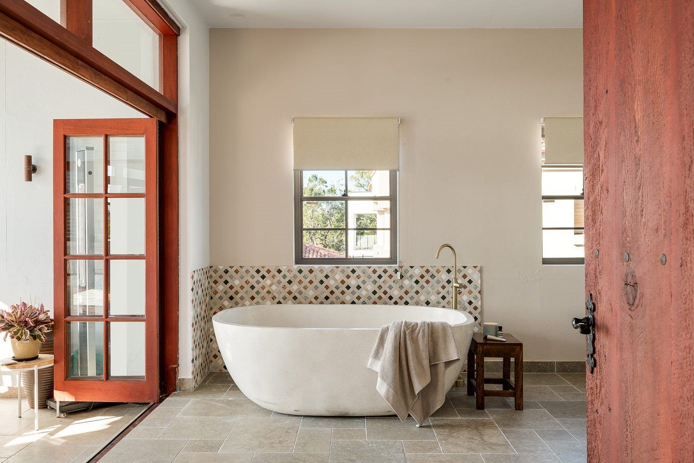 Ensuite bathroom with full bath and timber french doors in Riverside Brisbane interior design project