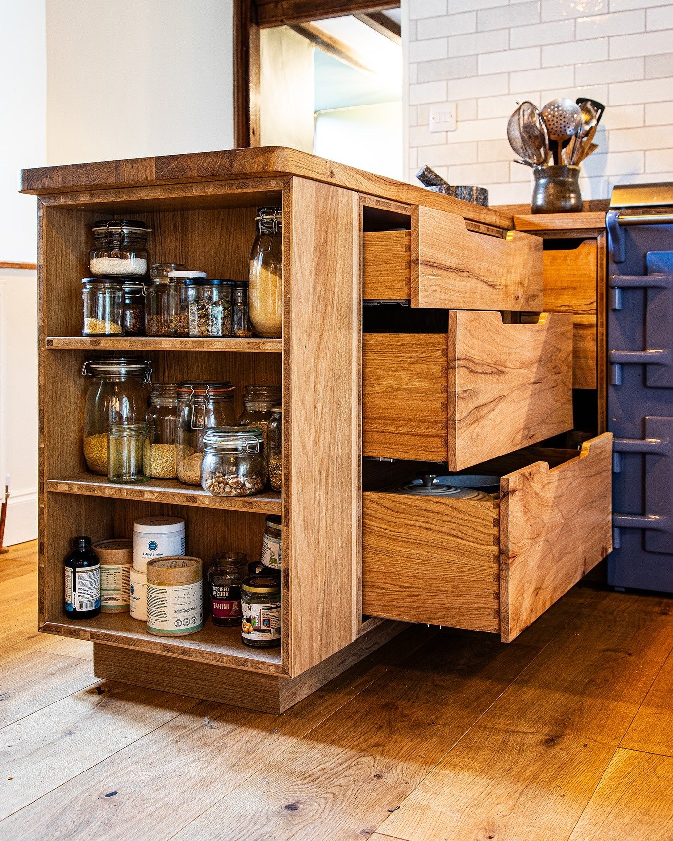 There is a lot of wood in this kitchen! Here is a breakdown of materials used:

Carcase: engineered oak
Drawer fronts: spalted beech
Worktops: solid oak
Cabinet doors: engineered oak frame and bookmatched spalted beech centre panel
Floor: engineered 