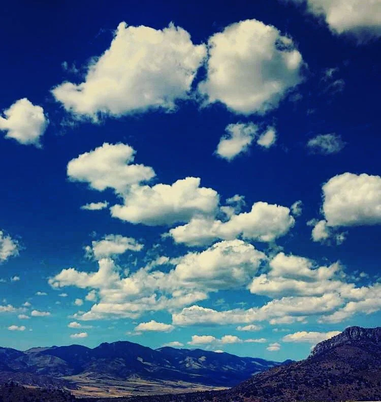 Cloudy sky over mountains and valleys.
