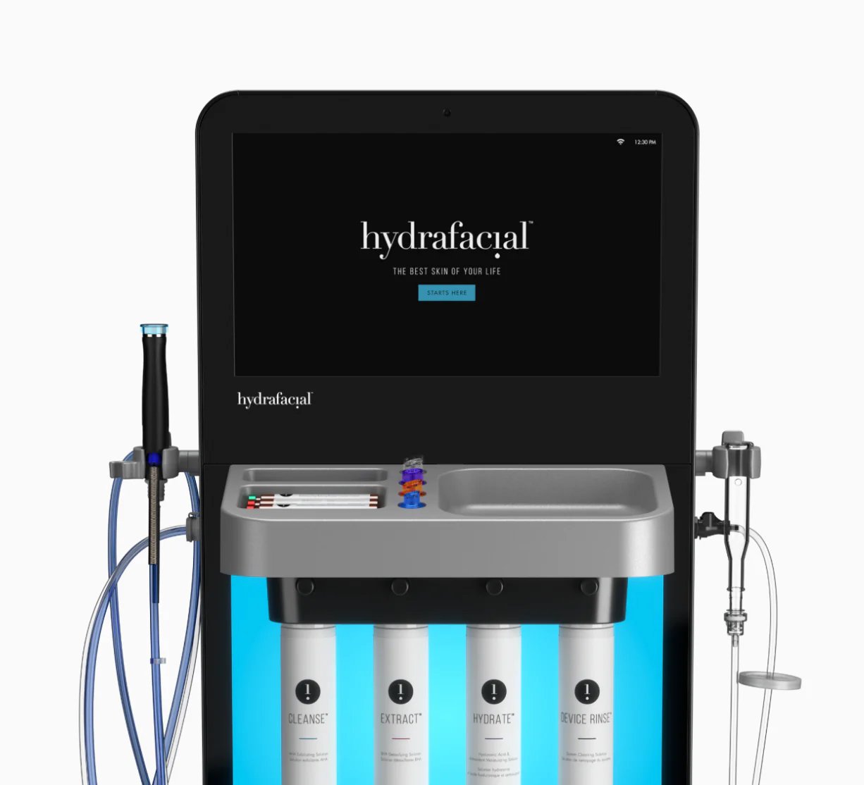Hydrafacial skincare machine with four labeled bottles and a large display screen showing the Hydrafacial logo and slogan.
