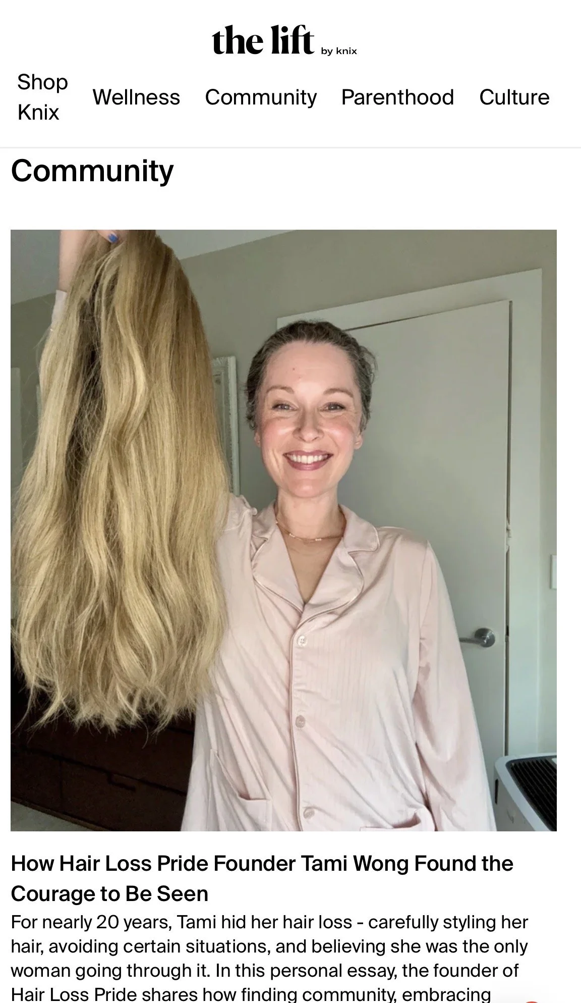Woman holding wig and smiling