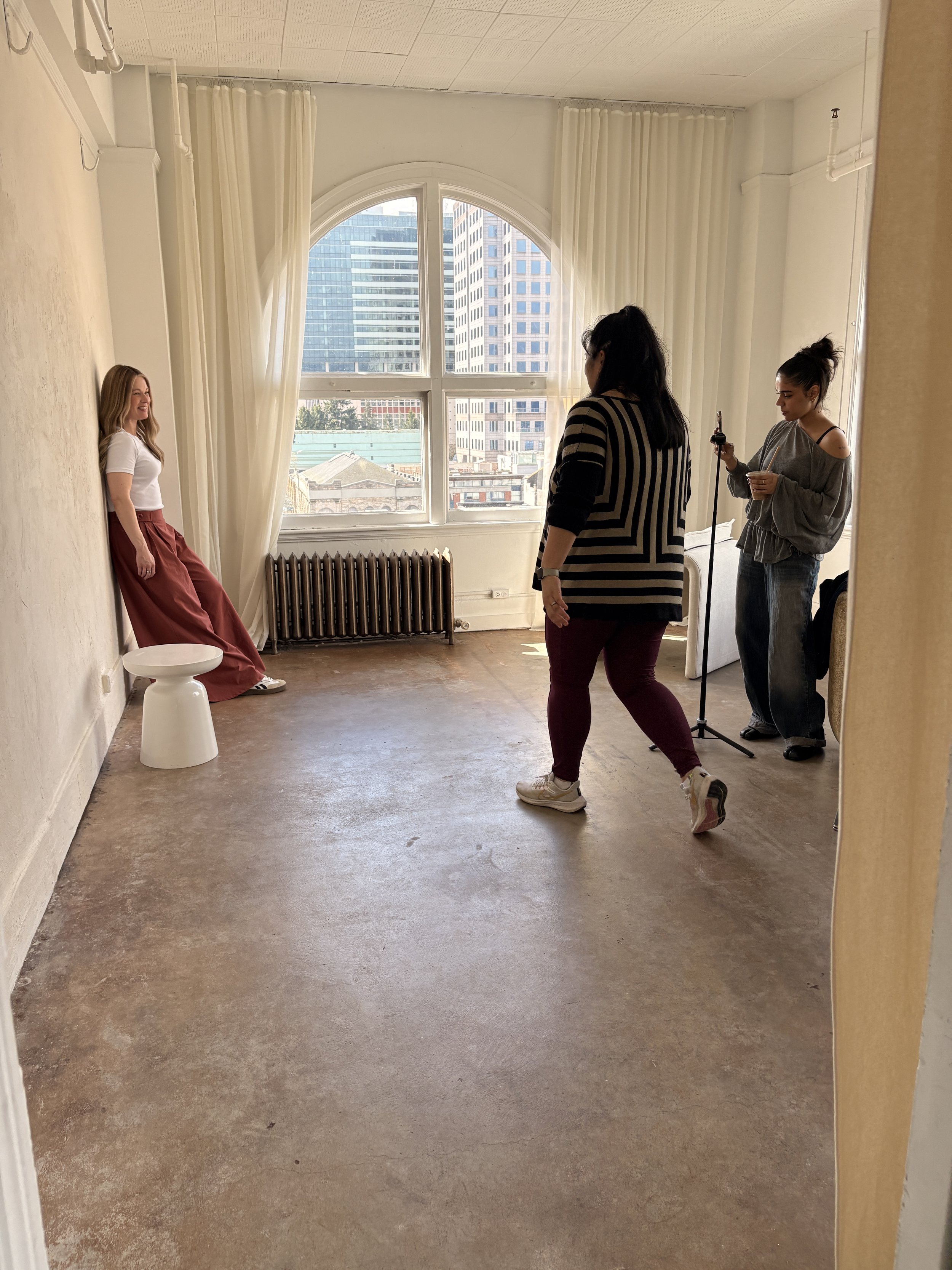Woman with hair loss wearing a wig and modeling for a fashion brand photoshoot in a studio