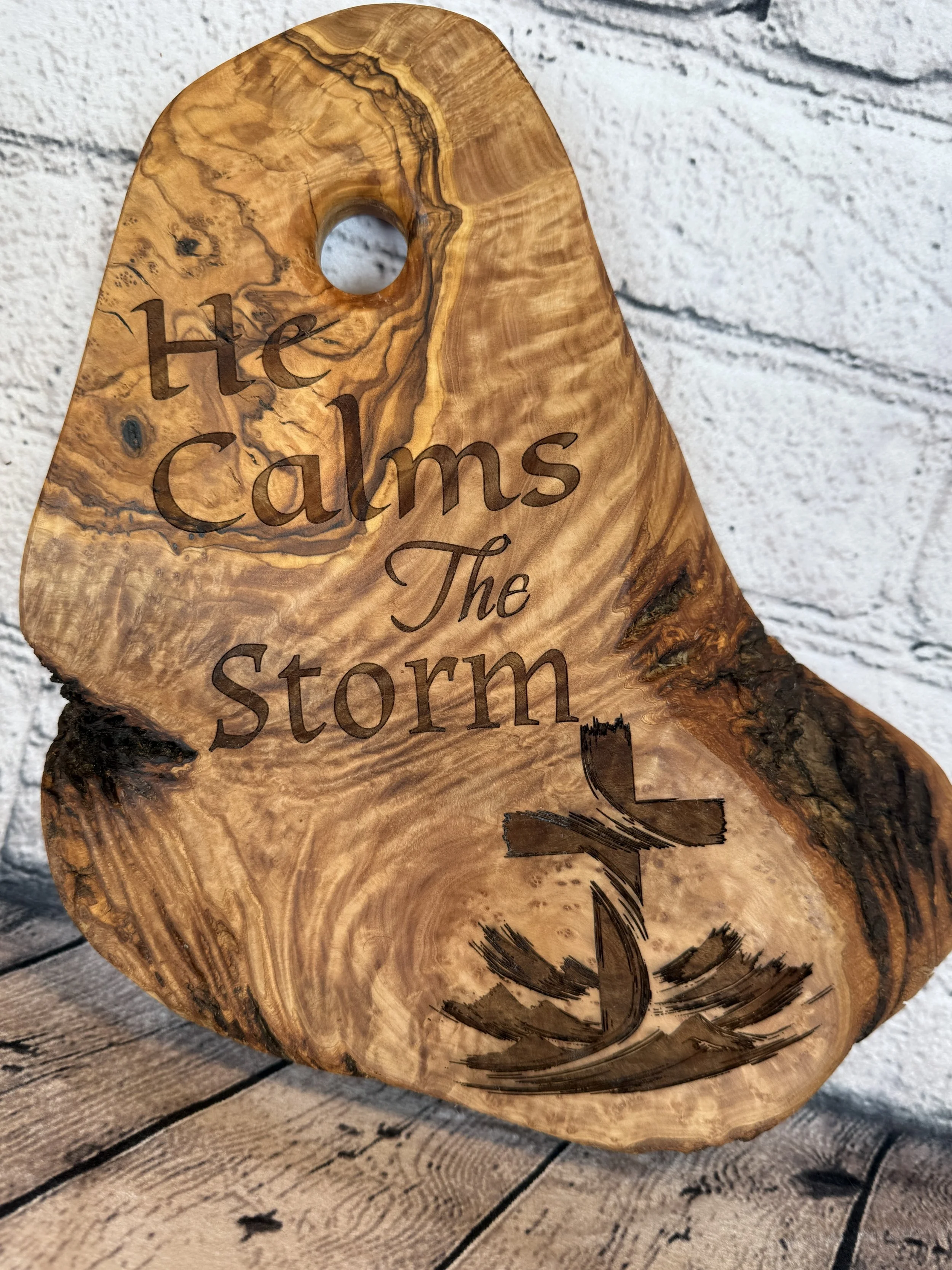 Olivewood with He Calms the Storm engraved on it