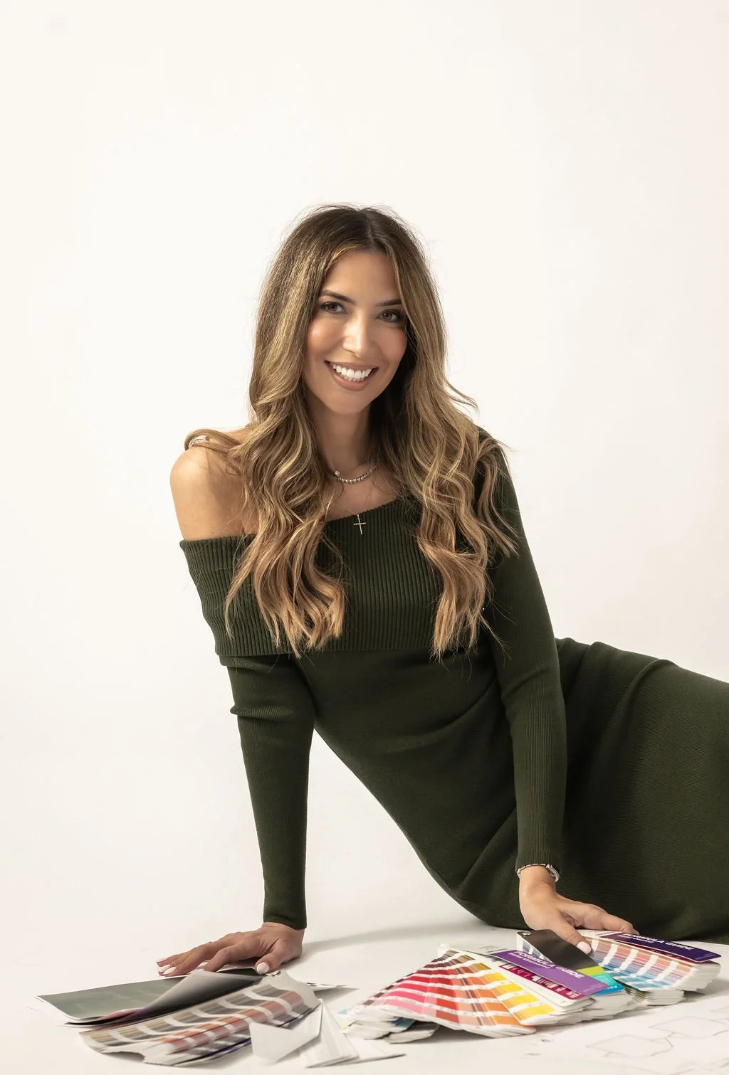 Natalia, fashion business consultant and founder of The Lines by Natalia, with Pantone color guides and fabric swatches