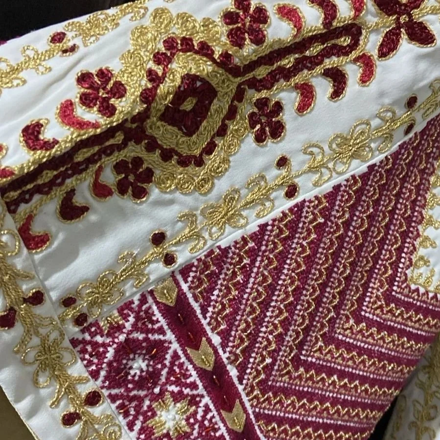Tahriri couching and Palestinian Fallahi cross-stitch embroidery used together on a garment