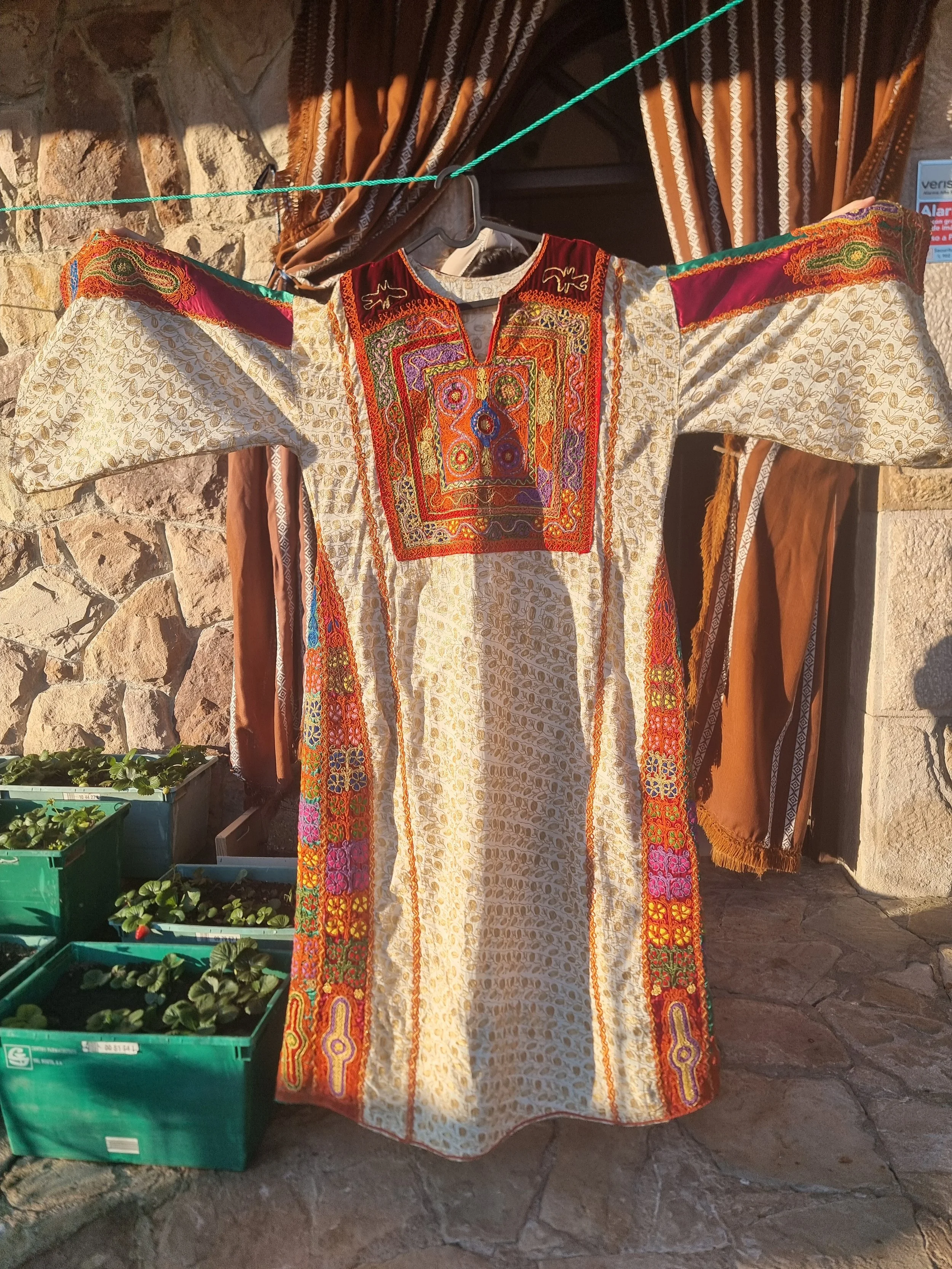 Palestinian dress decorated with colourful Tahriri embroidery on the chest and side panels