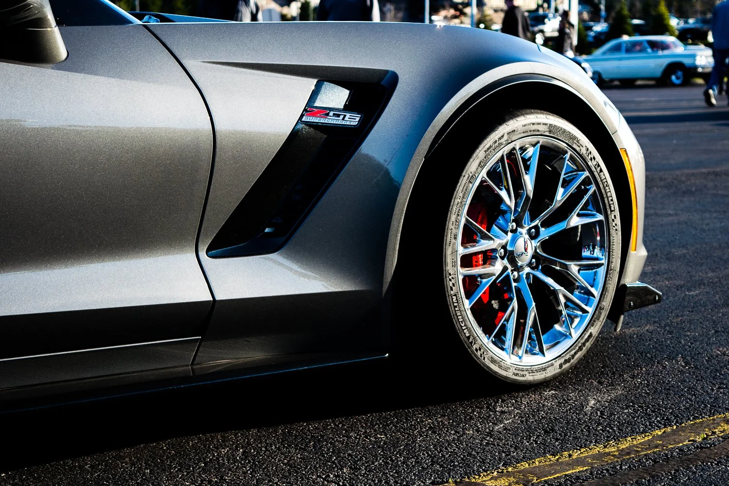 Photo os front tire of a sports car at a cruise night.