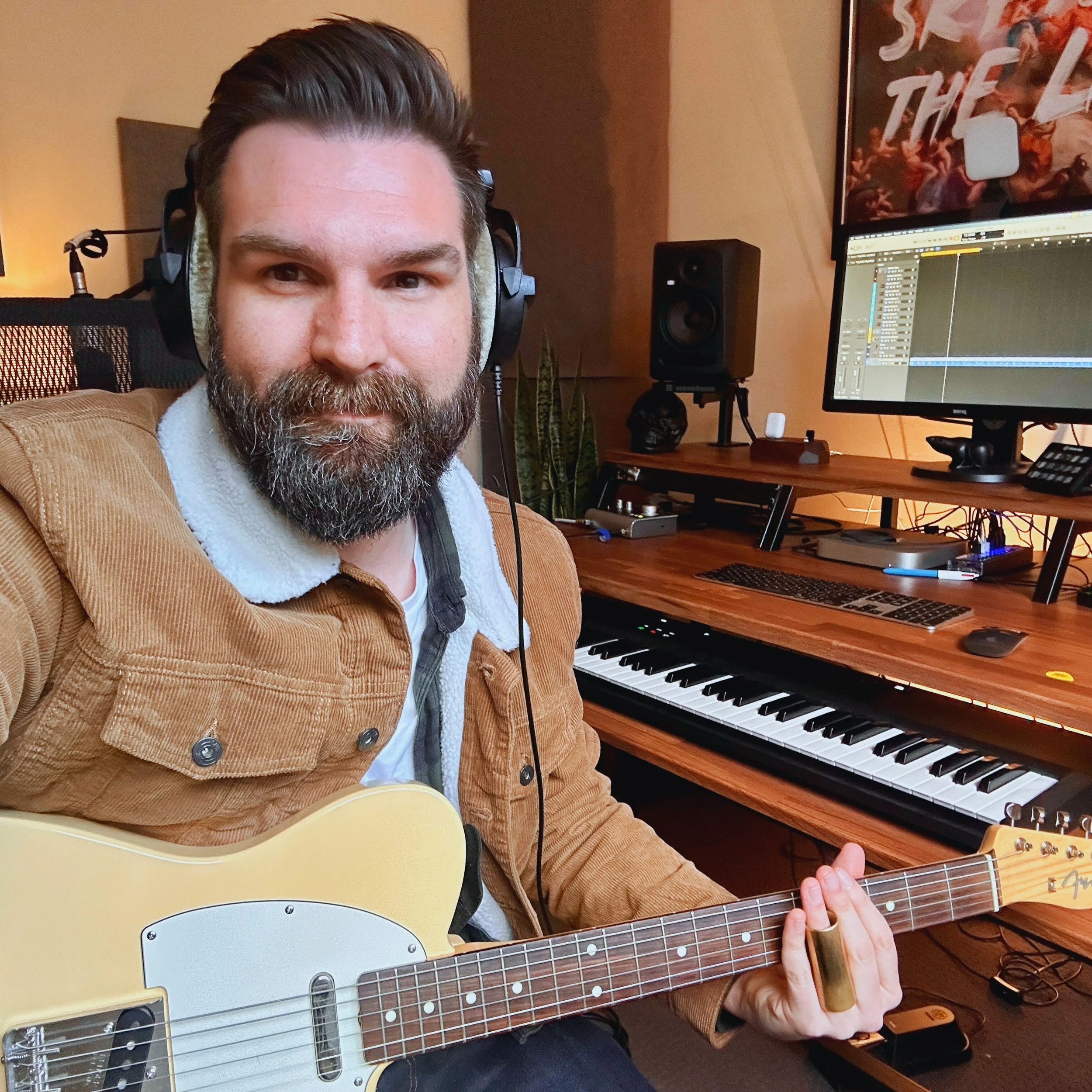Image of Zac Watson in a studio, holding an electric guitar.