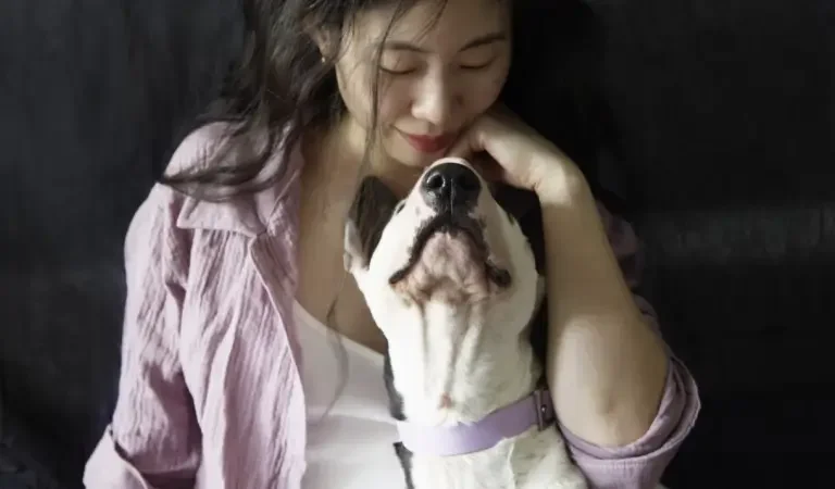 Woman gently hugging a dog
