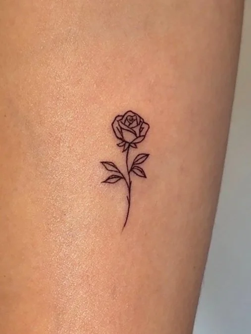 Delicate fine line flower tattoo on wrist – minimalist tiny tattoo near Beverly Hills at Iconink Cosmetic Tattoo Studio in West Los Angeles