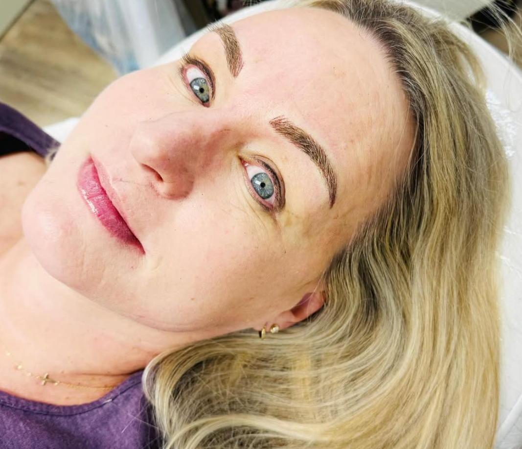 Woman smiling at camera with eyebrows nanobladed