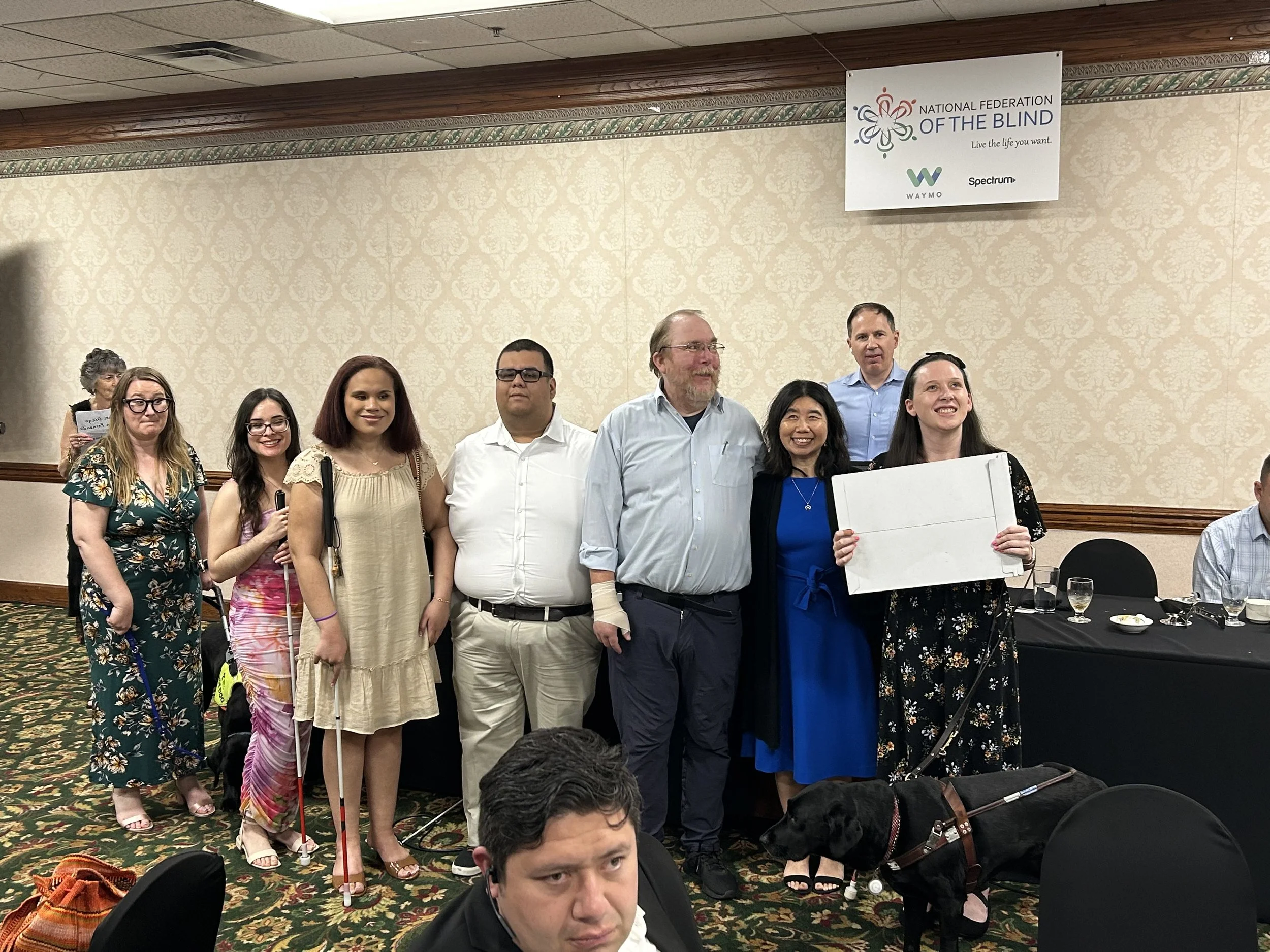 Lindsay and Eve alongside other chapter members of the Orange County NFB chapter receiving the chapter charter at the NFB of California banquet.