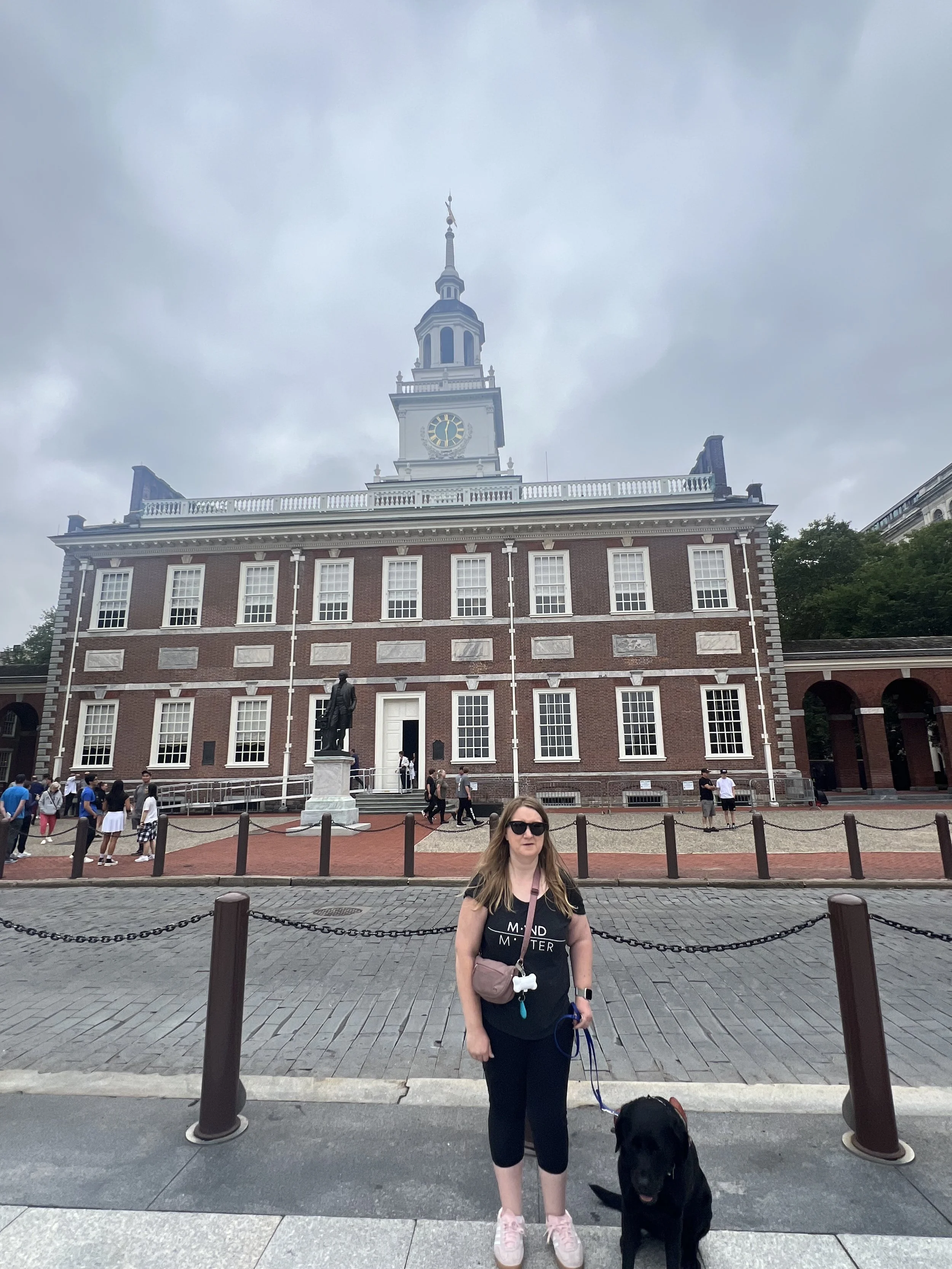 Lindsay standing, while Eve sitts in front of Independence Hall.