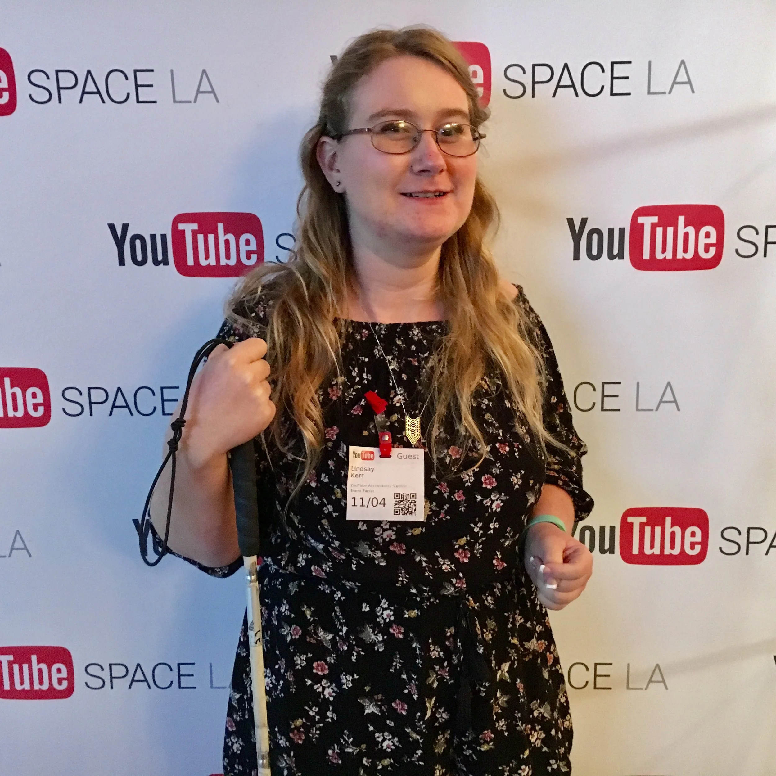Lindsay at YouTube Space LA holding her white cane.