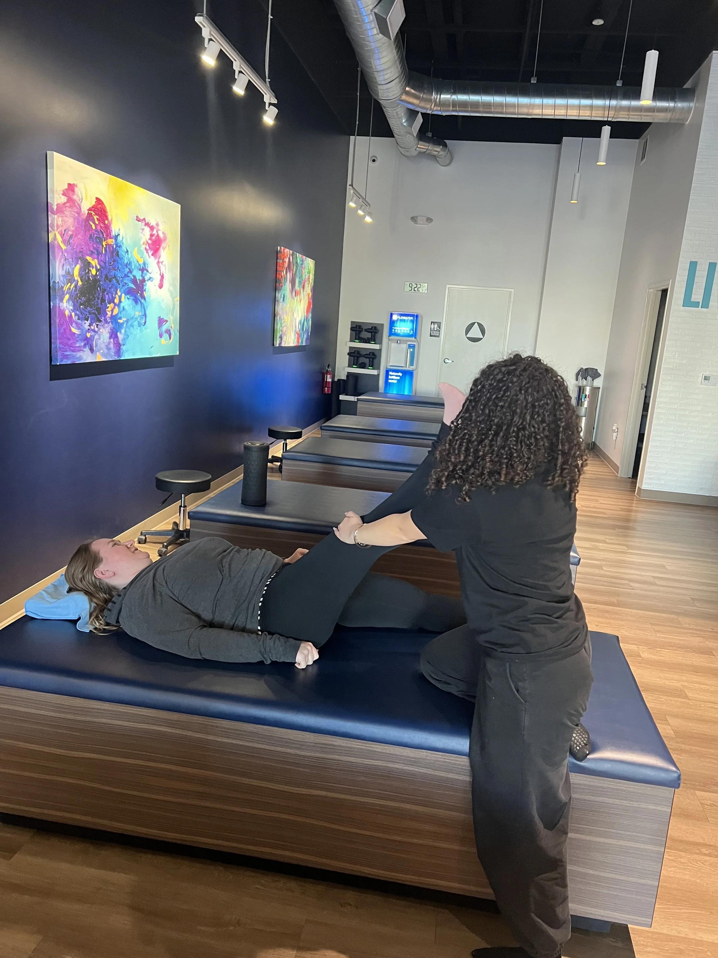 Lindsay being stretched by a flexologist.