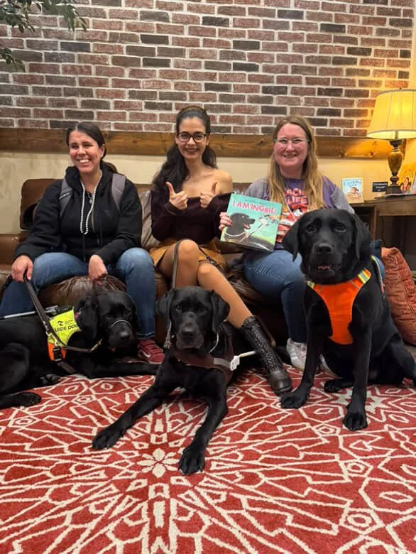 Paulina, Ophilia, Aria, Ingrid, Lindsay, and Eve sitting together while holding Aria’s book I am Ingrid.