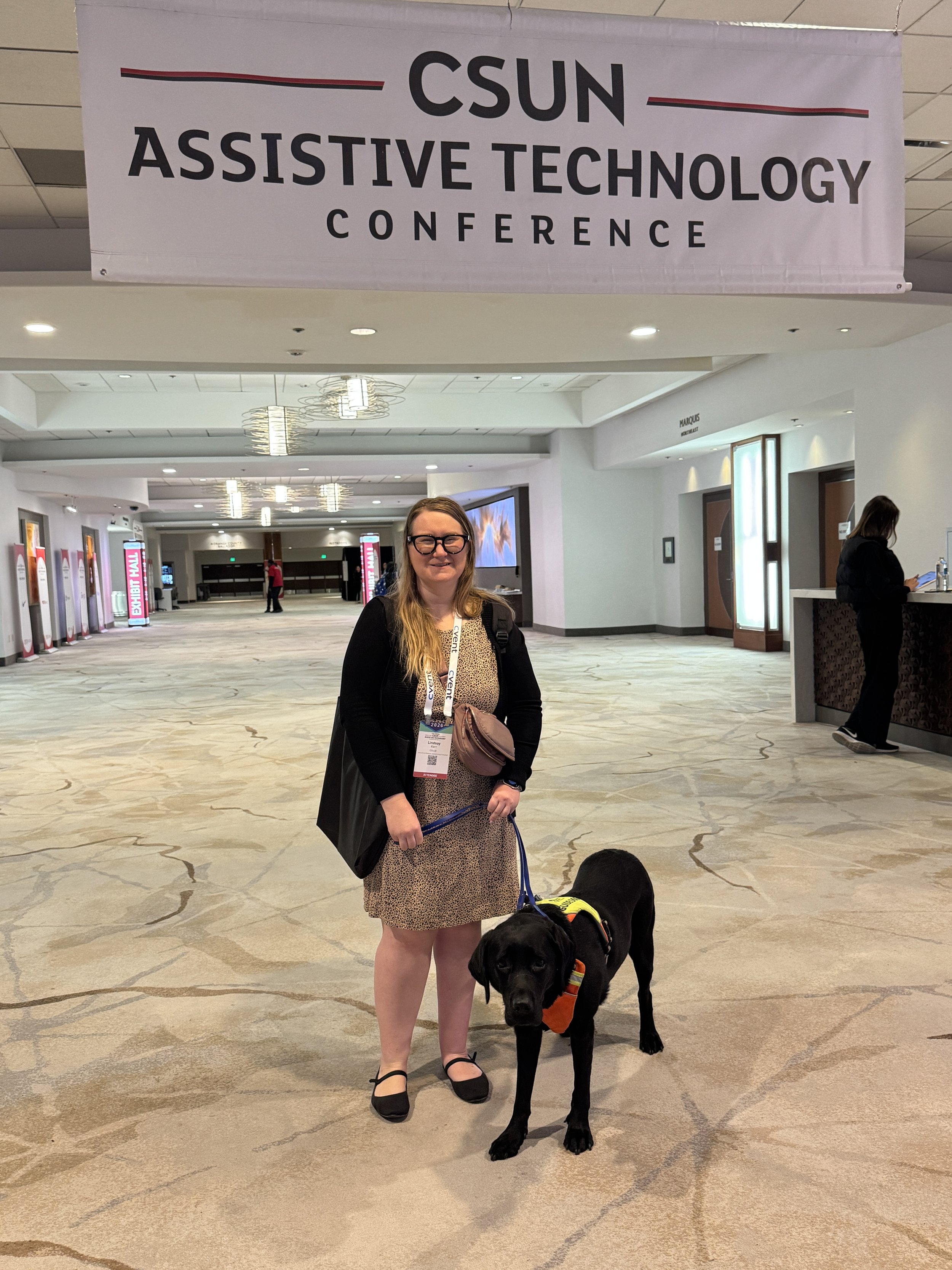 Lindsay and Eve under the California State University Northridge Assistive Technology Confrence banner.
