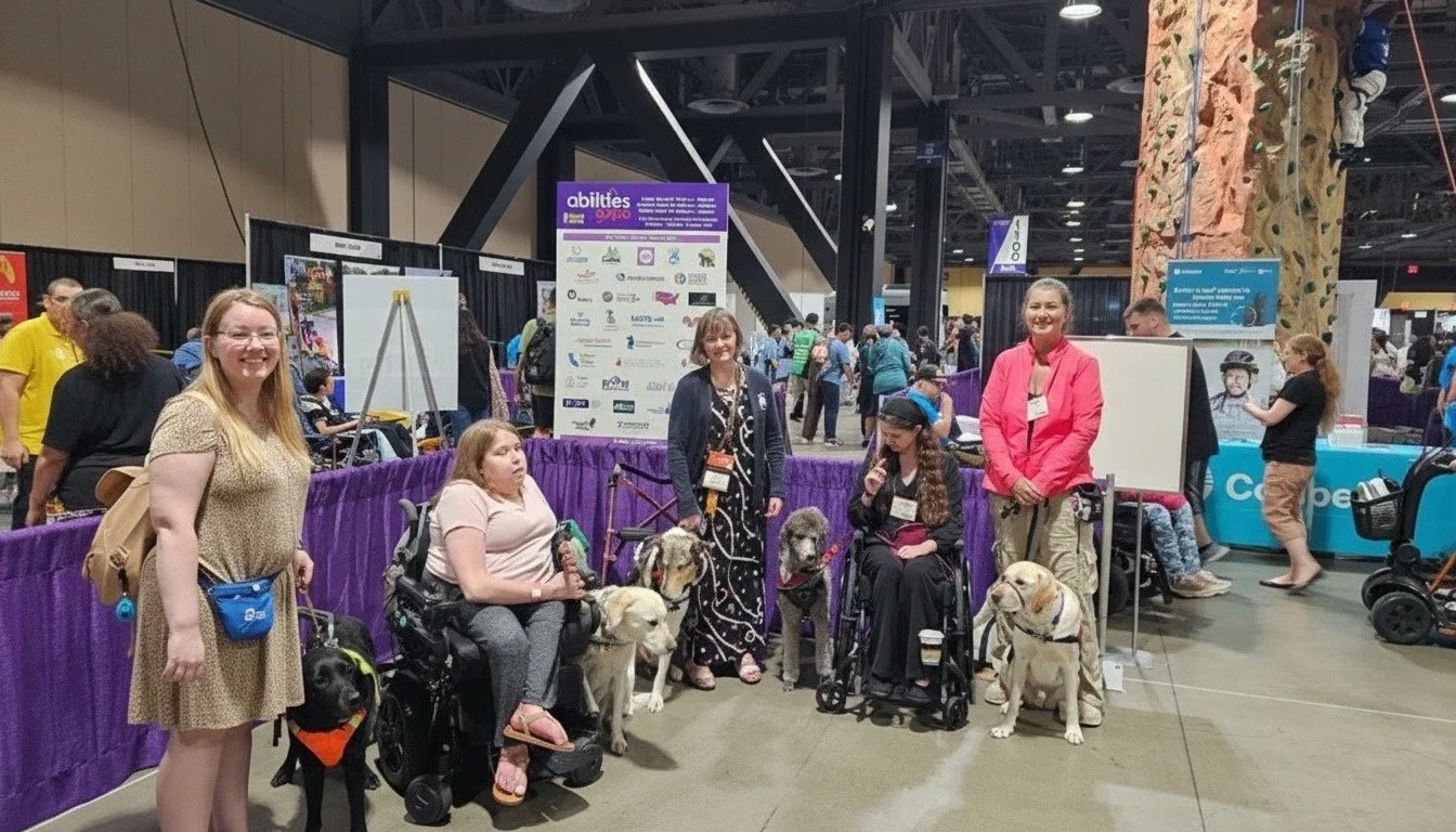 Lindsay and Eve standing with other service animal handlers after presenting to a group at the Long Beach Abilities Expo.