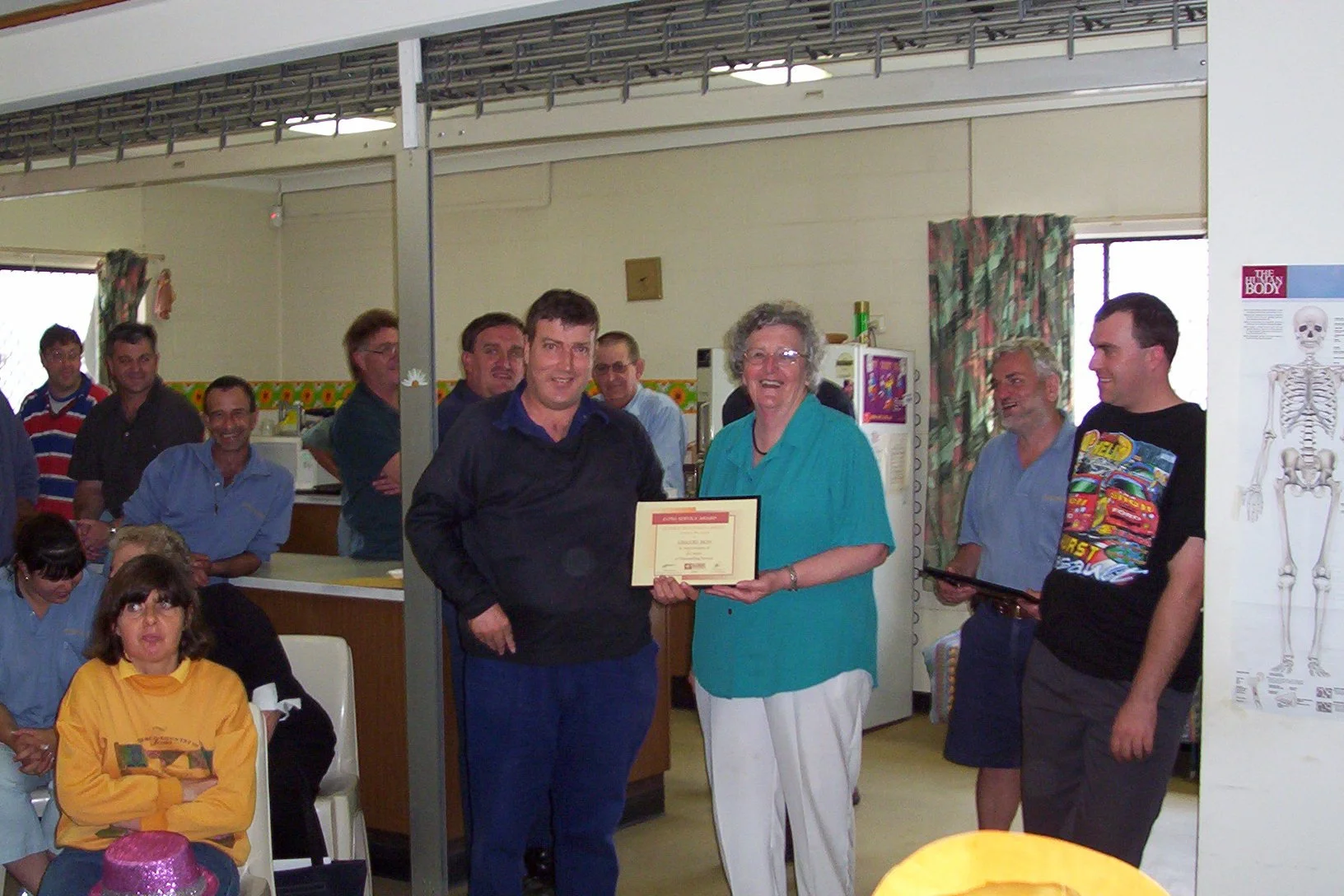 Greg is presented with his 20 year milestone award, November 2004