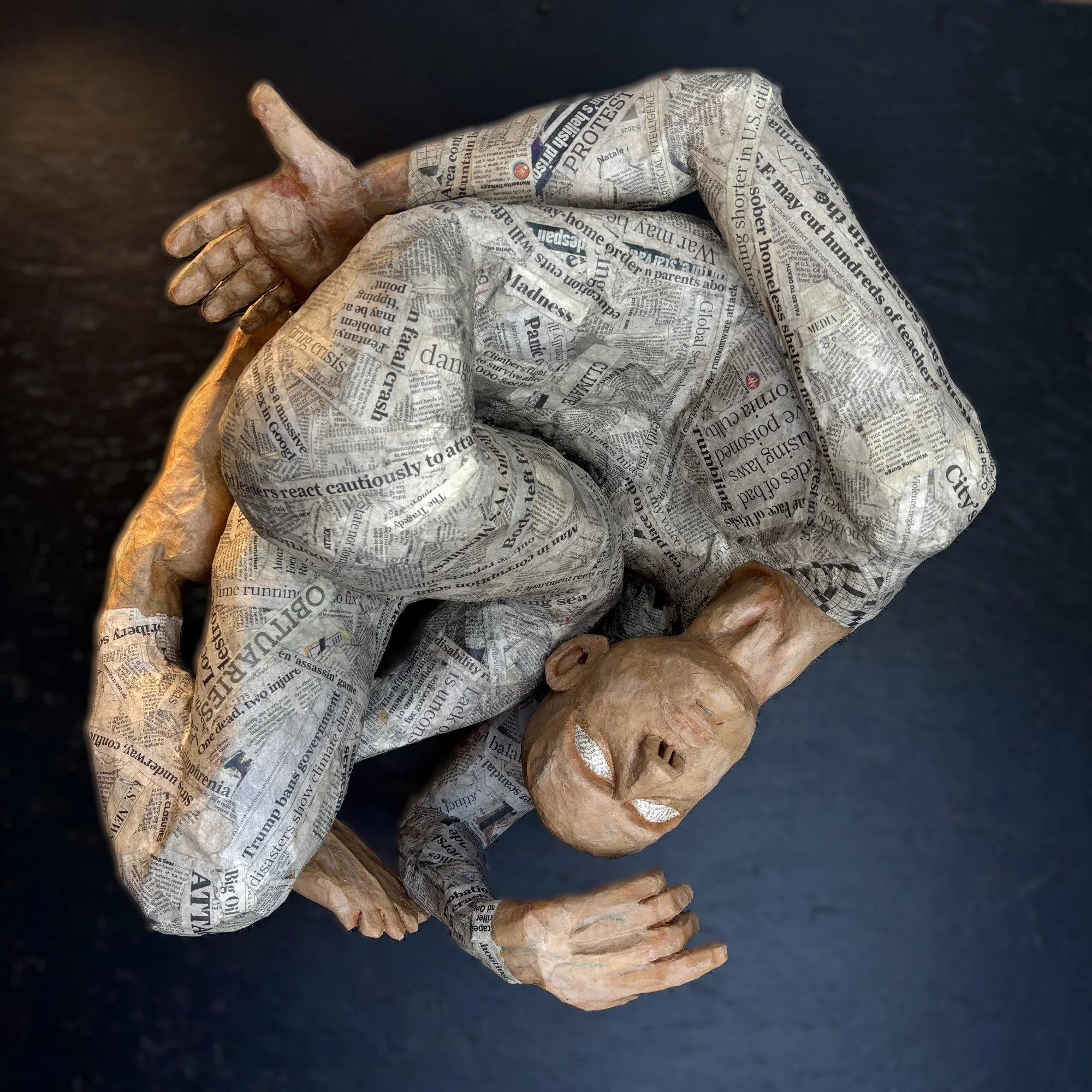 OVERCONSUMPTION LED TO THE BOTTOM life-sized paper mache