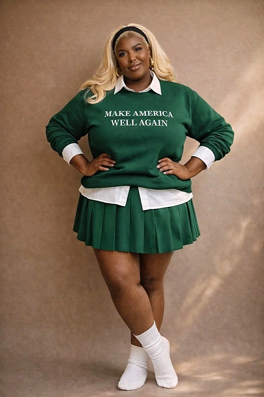 A woman with blonde hair wearing a black headband, white collared shirt, green sweater with white text 'MAKE AMERICA WELL AGAIN,' green pleated skirt, and white socks, standing with hands on hips against a beige background.