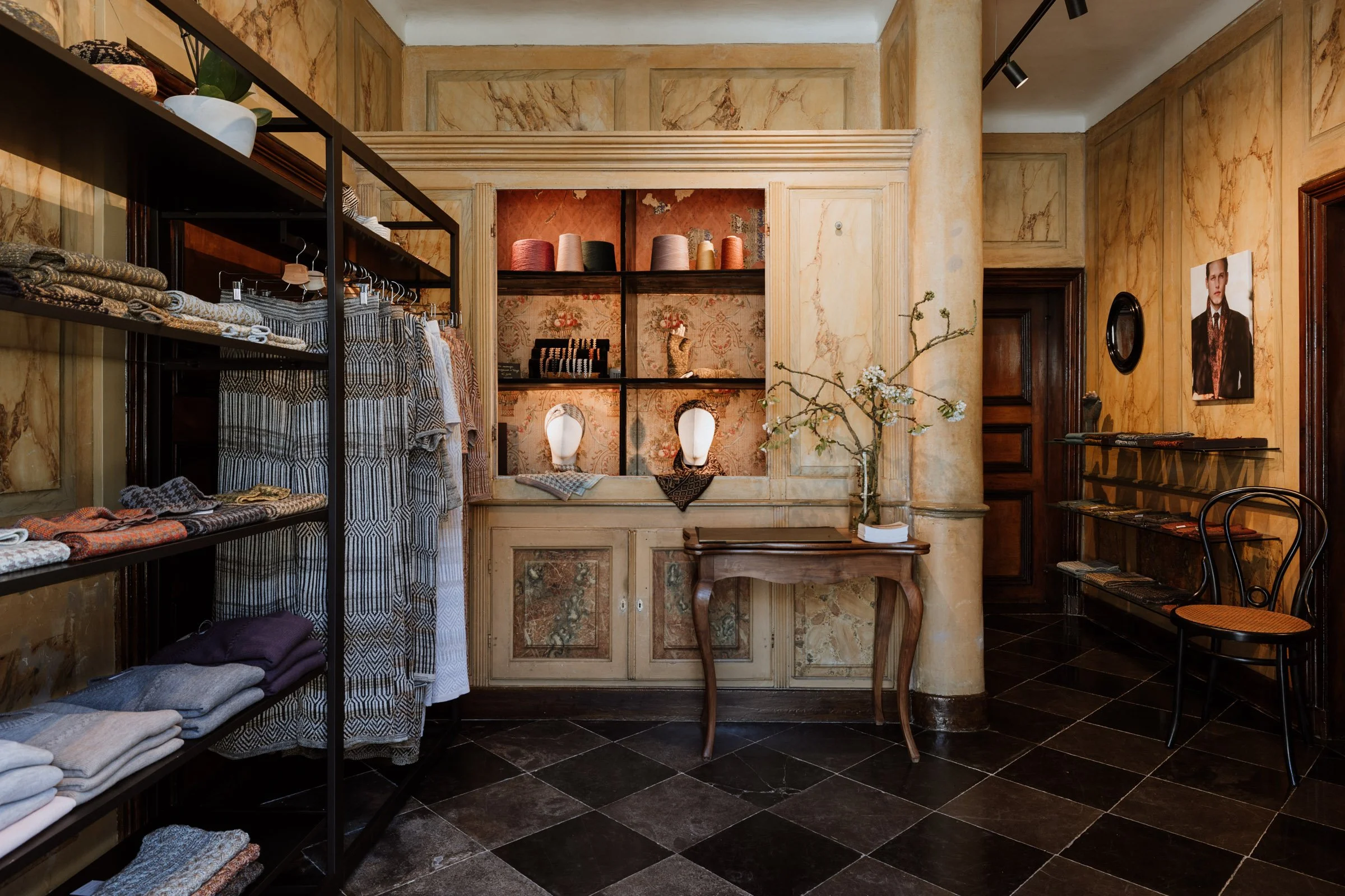 Interior of the Studio Myr boutique, displaying handcrafted knitwear in the marble-finished entrance hall of an eighteenth-century house in Thorn.