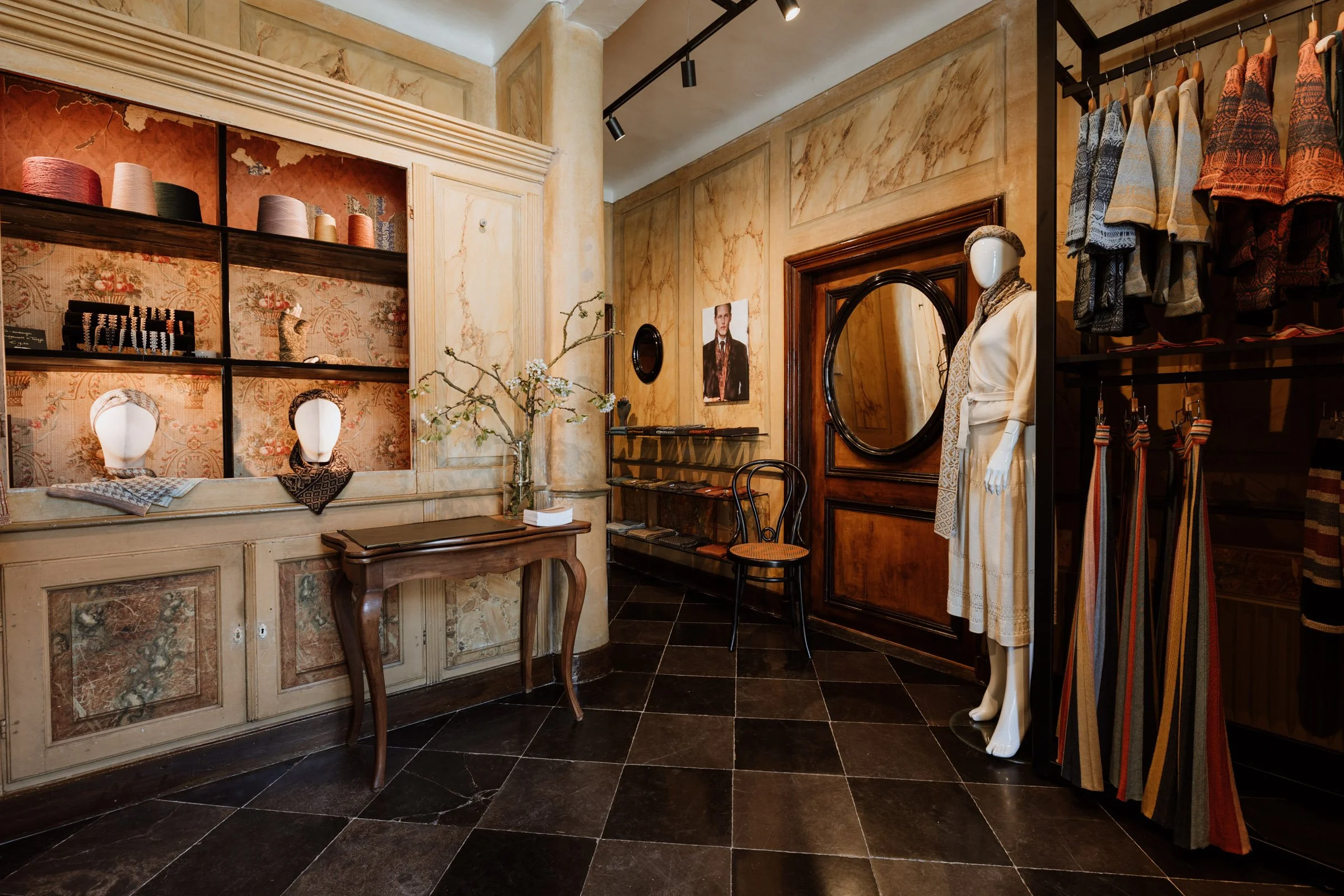 Interior of the Studio Myr boutique, displaying handcrafted knitwear in the marble-finished entrance hall of an eighteenth-century house in Thorn.