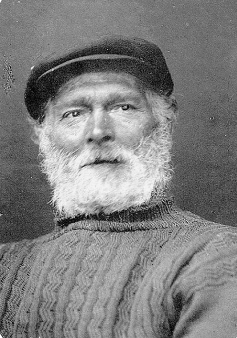 Title: Elderly Fisherman Wearing a Hand-Knitted Aran Jumper