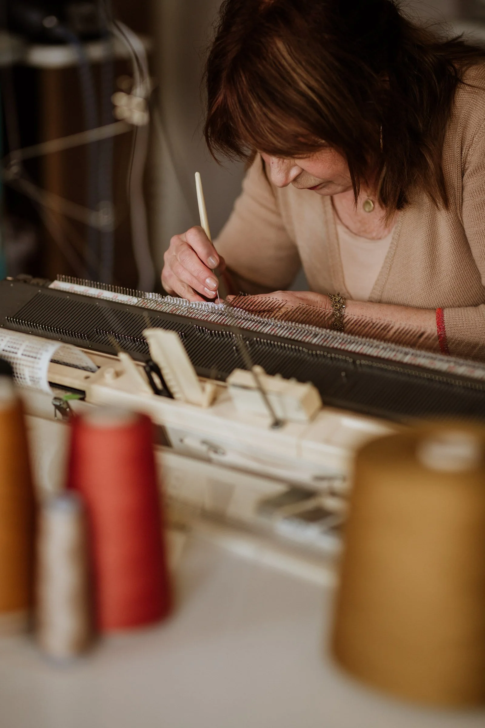 Studio Myr founder finishing knitwear by hand in the atelier in Thorn, the Netherlands
