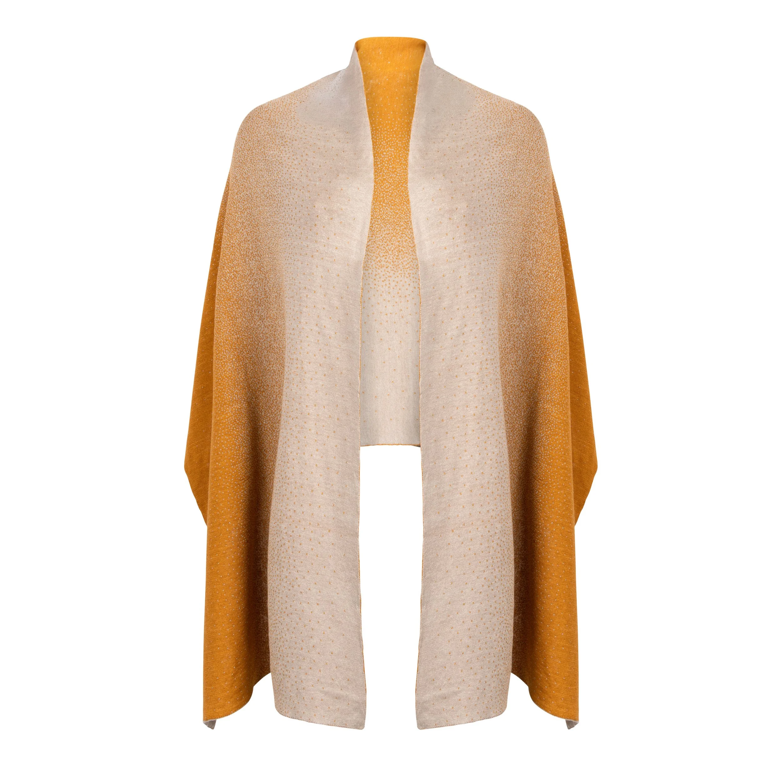 Sunset – Bali, a soft gradient knit wrap featuring harmonious shades of ivory and warm amber, draped effortlessly over the shoulders.