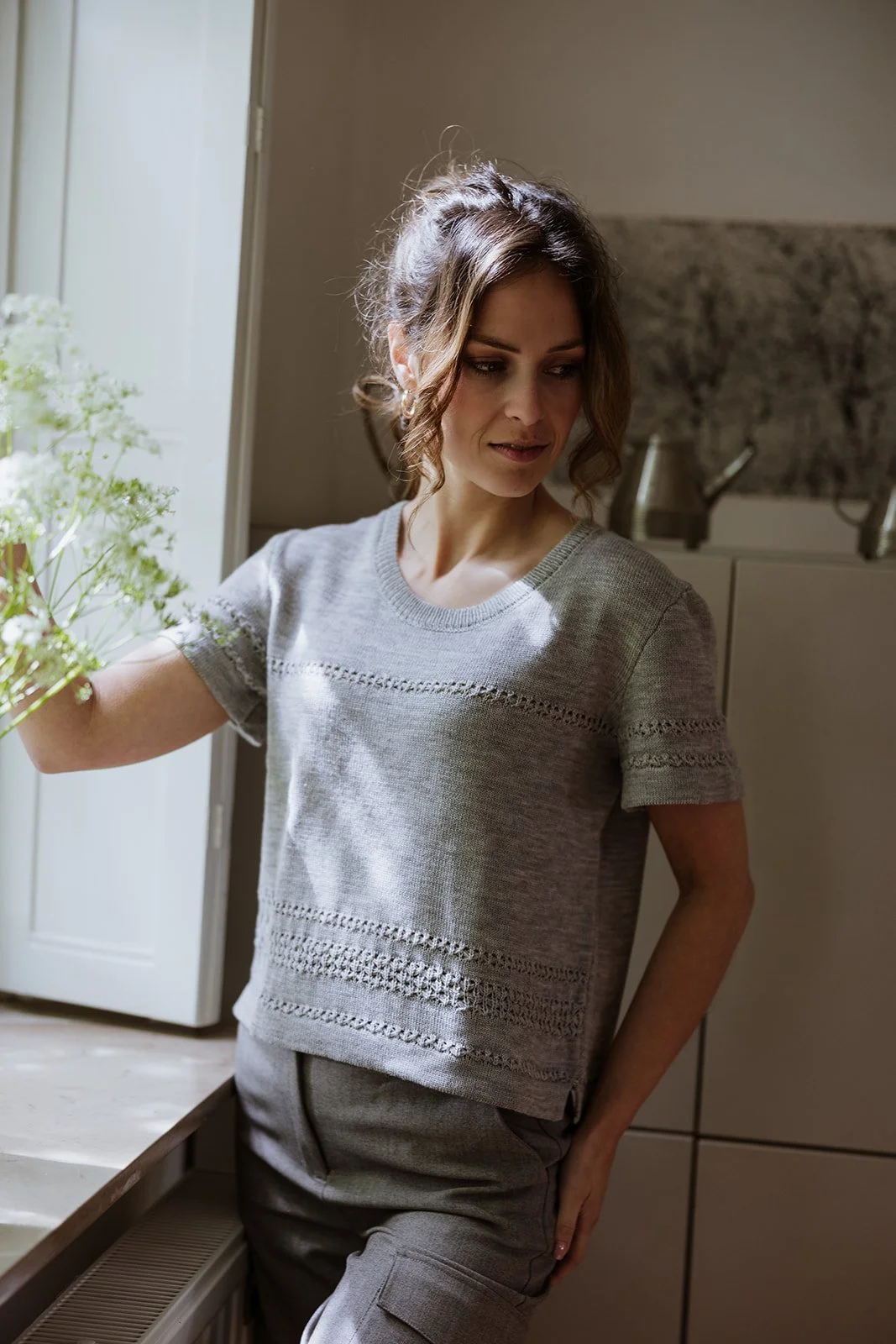 Woman wearing Studio Myr Merino Lace Knit Tee in Mouse grey, crafted in extra fine Merino wool