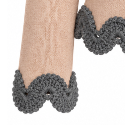 Close-up of the Gabriella jumper sleeve showing intricate dark grey hand-crocheted Baby Alpaca lace against fine beige Merino wool knit.