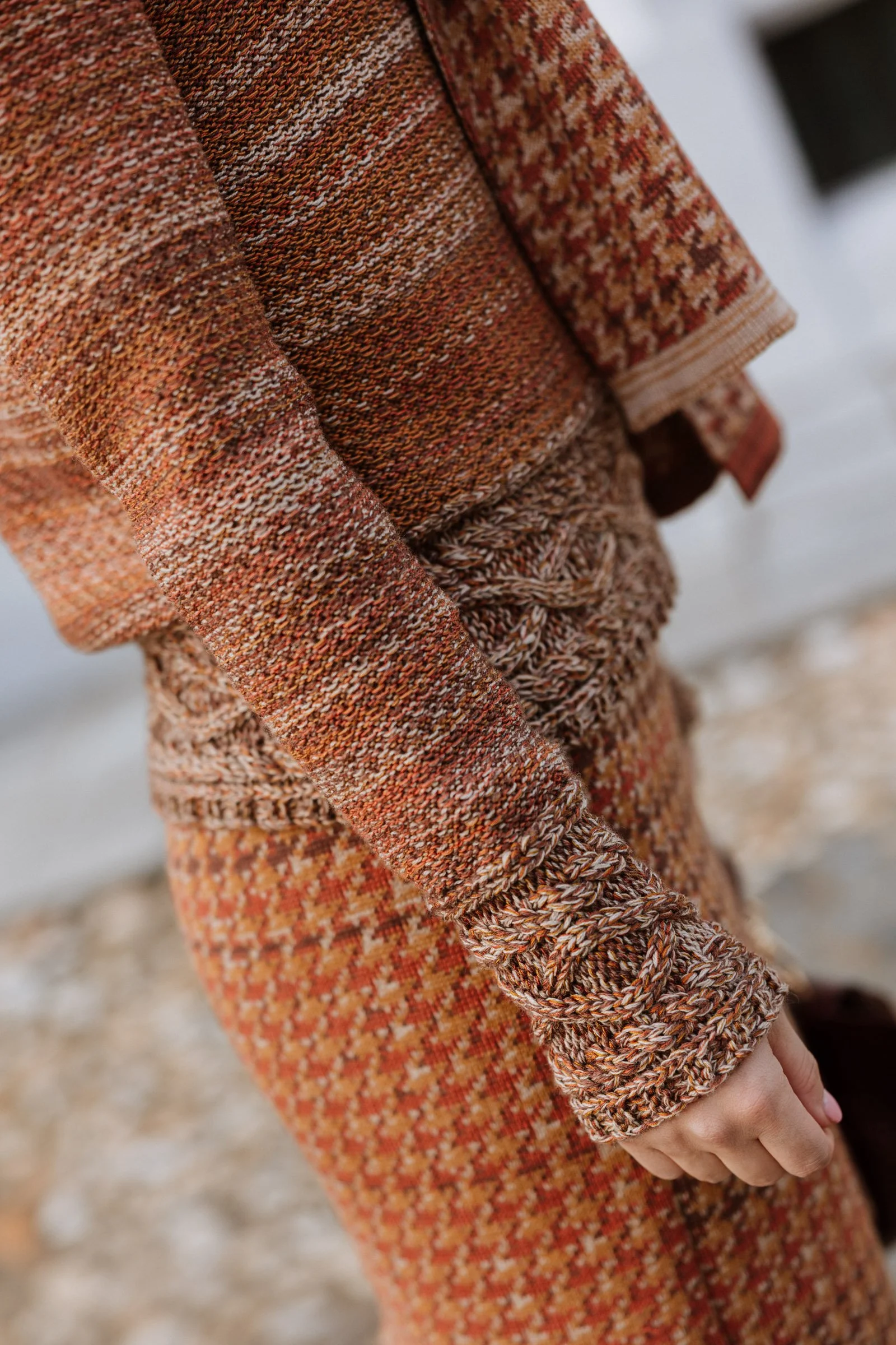 Close-up of knitted sleeves and cuffs, showing colour nuances and the precision of the knit structure.