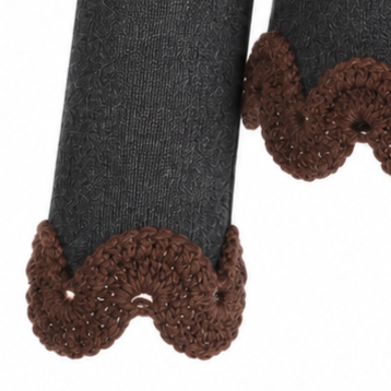 Close-up of the Francisca jumper sleeve showing chocolate brown hand-crocheted Baby Alpaca scalloped lace against fine charcoal grey Merino knit.