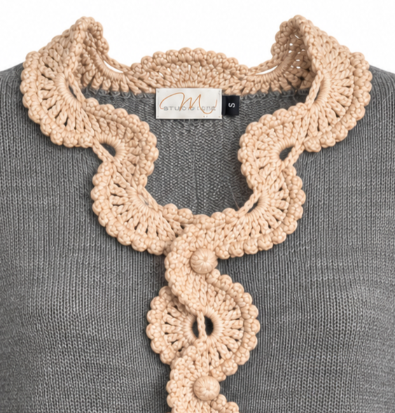 Close-up of the Gabriella Jacket showing intricate beige Baby Alpaca crochet lace framing the neckline and decorative front fastening against fine grey Merino knit.