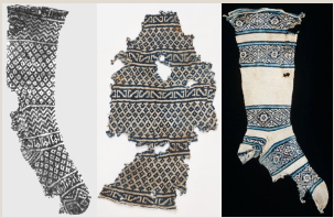 Fragmented and restored blue-and-white knitted socks from Egypt, dated around 1500 AD, showcasing some of the earliest known examples of intricate patterned knitting.