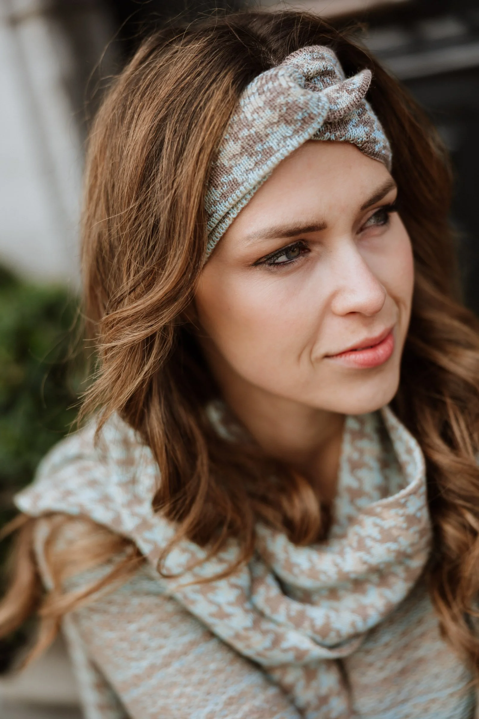 Close-up portrait of a model wearing a Studio Myr headband and scarf, focusing on softness and pattern detail.