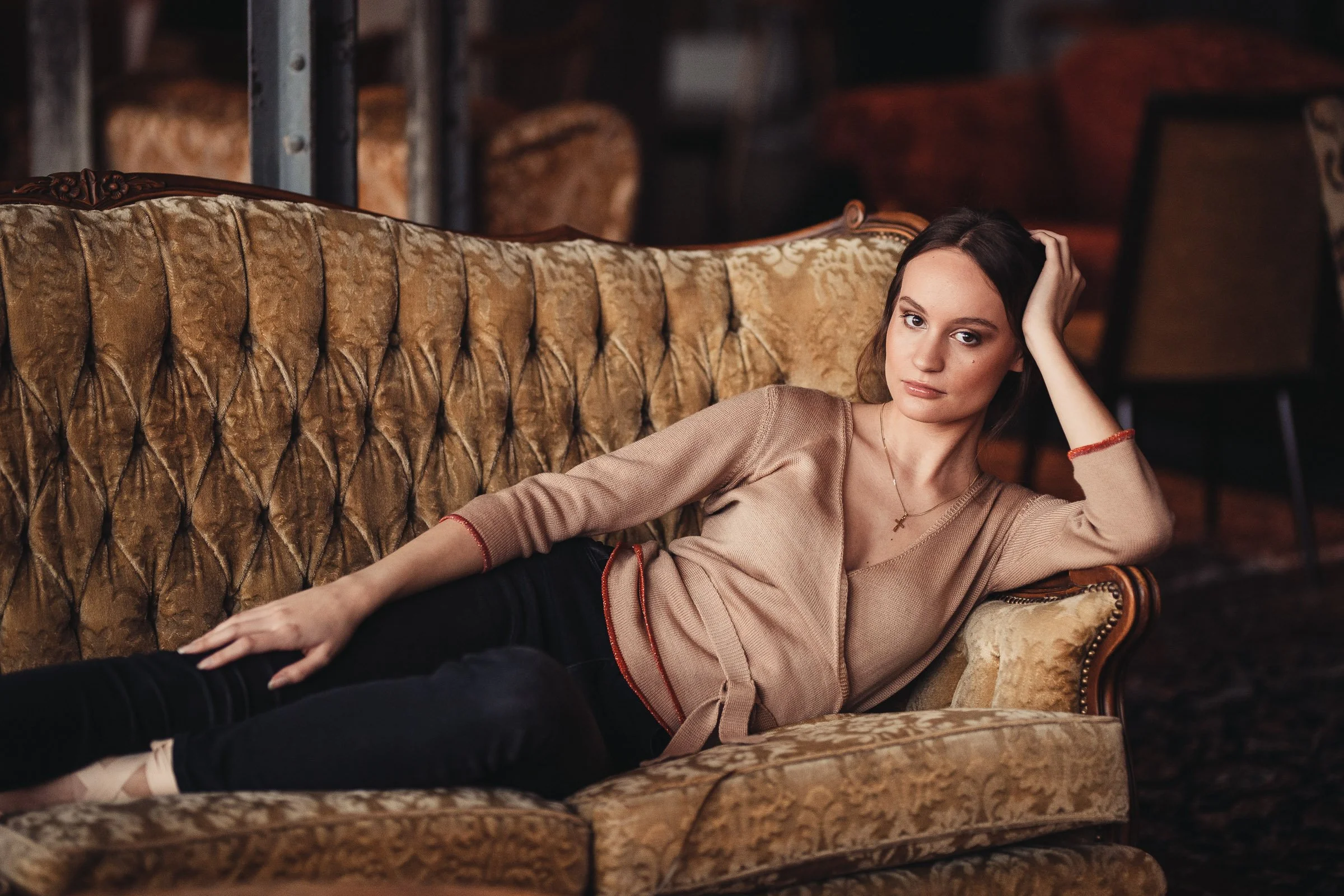 Woman wearing a beige knitted wrap top with red details from the Studio Myr Sweeties collection.