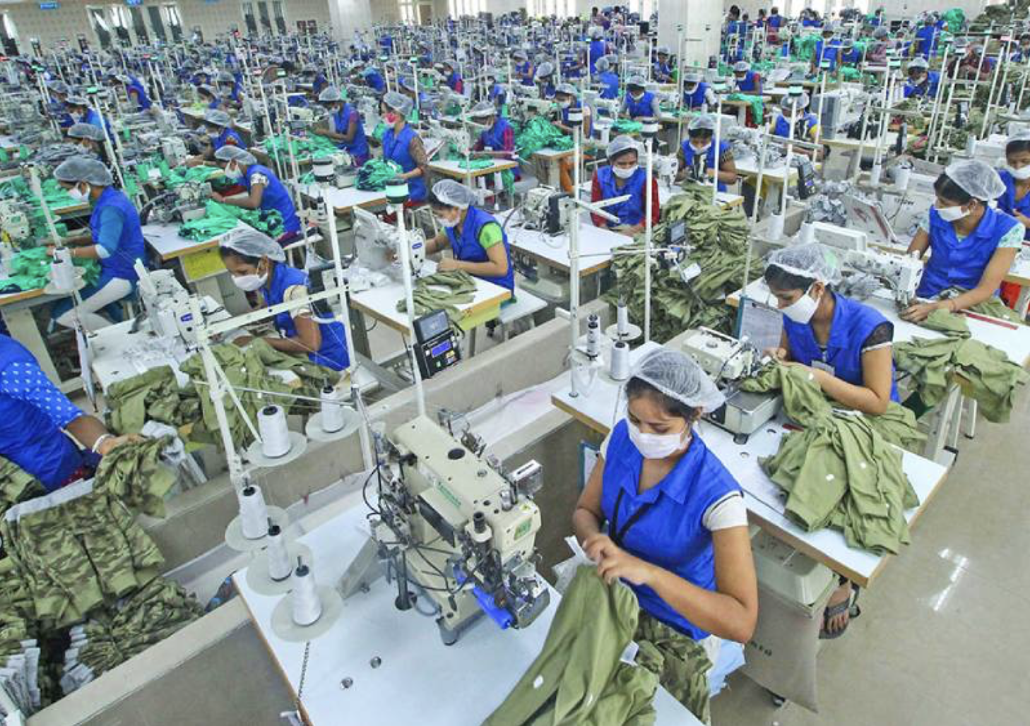 Large-scale textile factory in Bangladesh, showing industrial garment production in contrast to traditional craft practices.