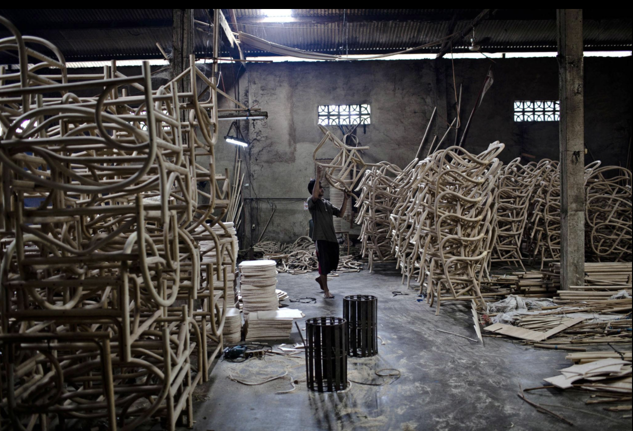 Workshop in Indonesia producing rattan chairs at scale, where traditional craft forms are adapted to mass production