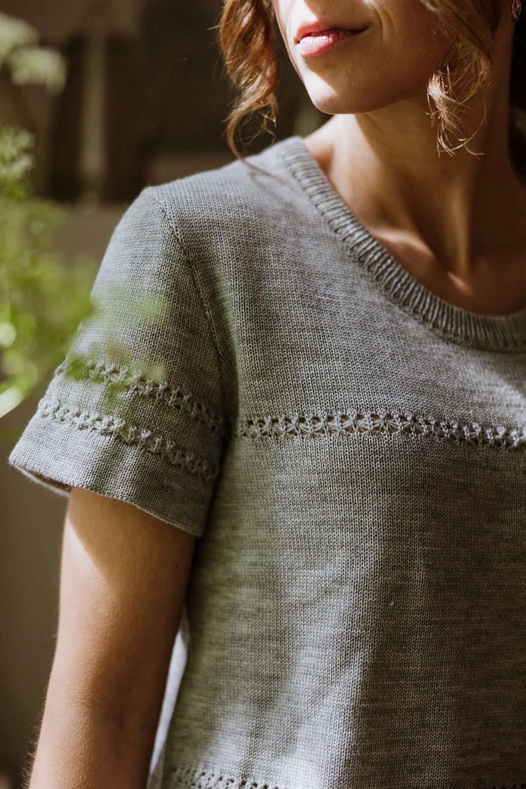 Detail of lace-knit structure on Studio Myr Merino Lace Knit Tee in Mouse grey