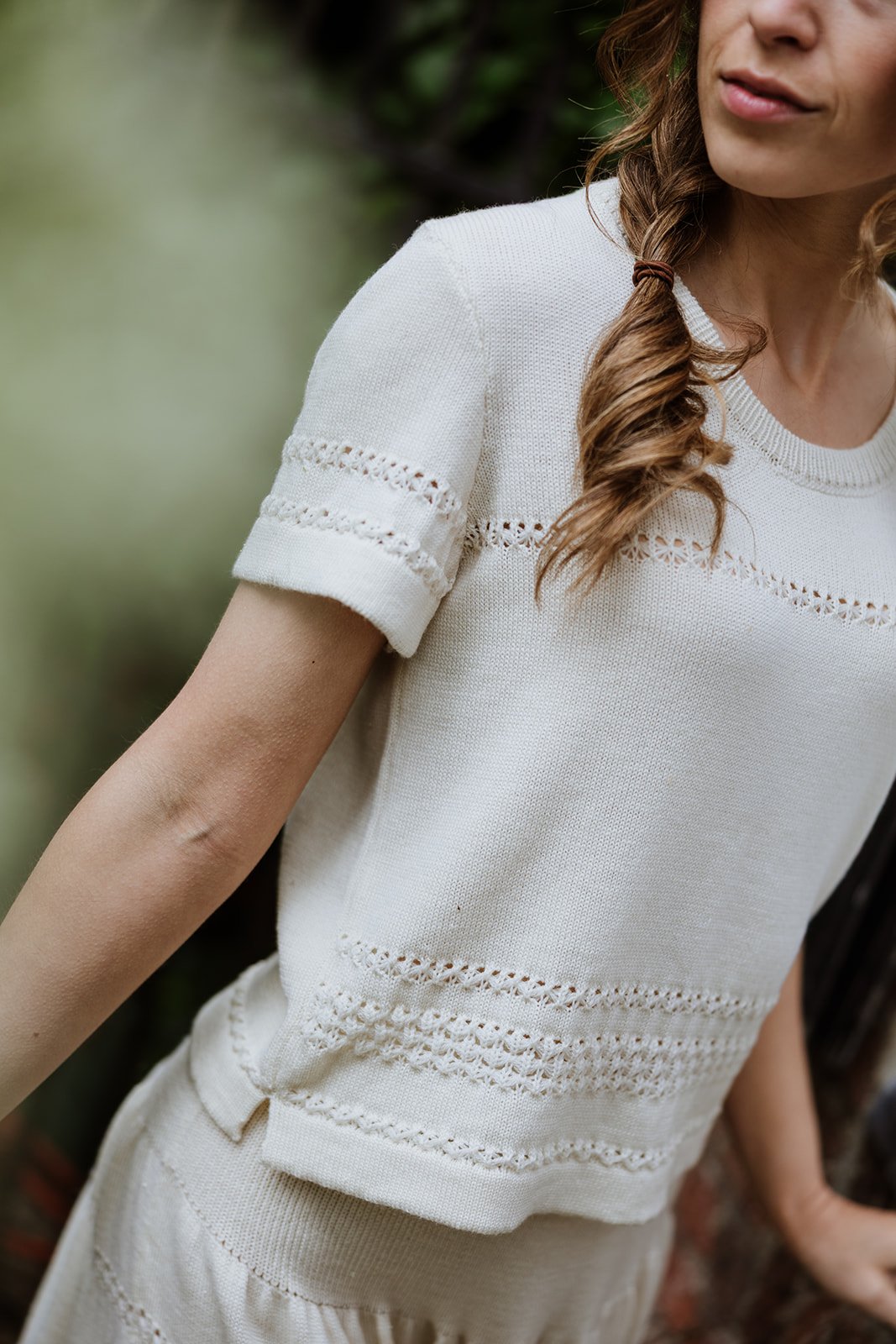 Detail of lace-knit sleeve and texture on Studio Myr Merino Lace Knit Tee in Pearl