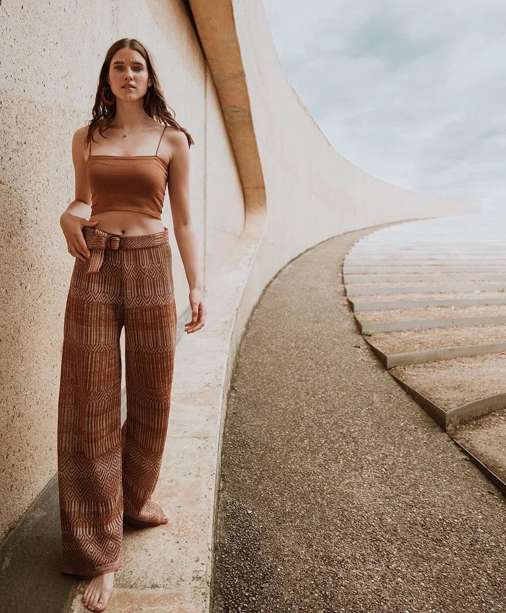 Graphic jacquard knitted wide leg trousers in linen blend of rust brown and neutrals front view