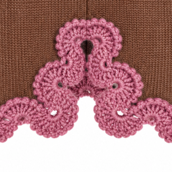 Close-up of the Eleonora Skirt's centre back slit, featuring intricate Dusty Rose hand-crocheted Baby Alpaca lace against Hazel Brown Merino knit.
