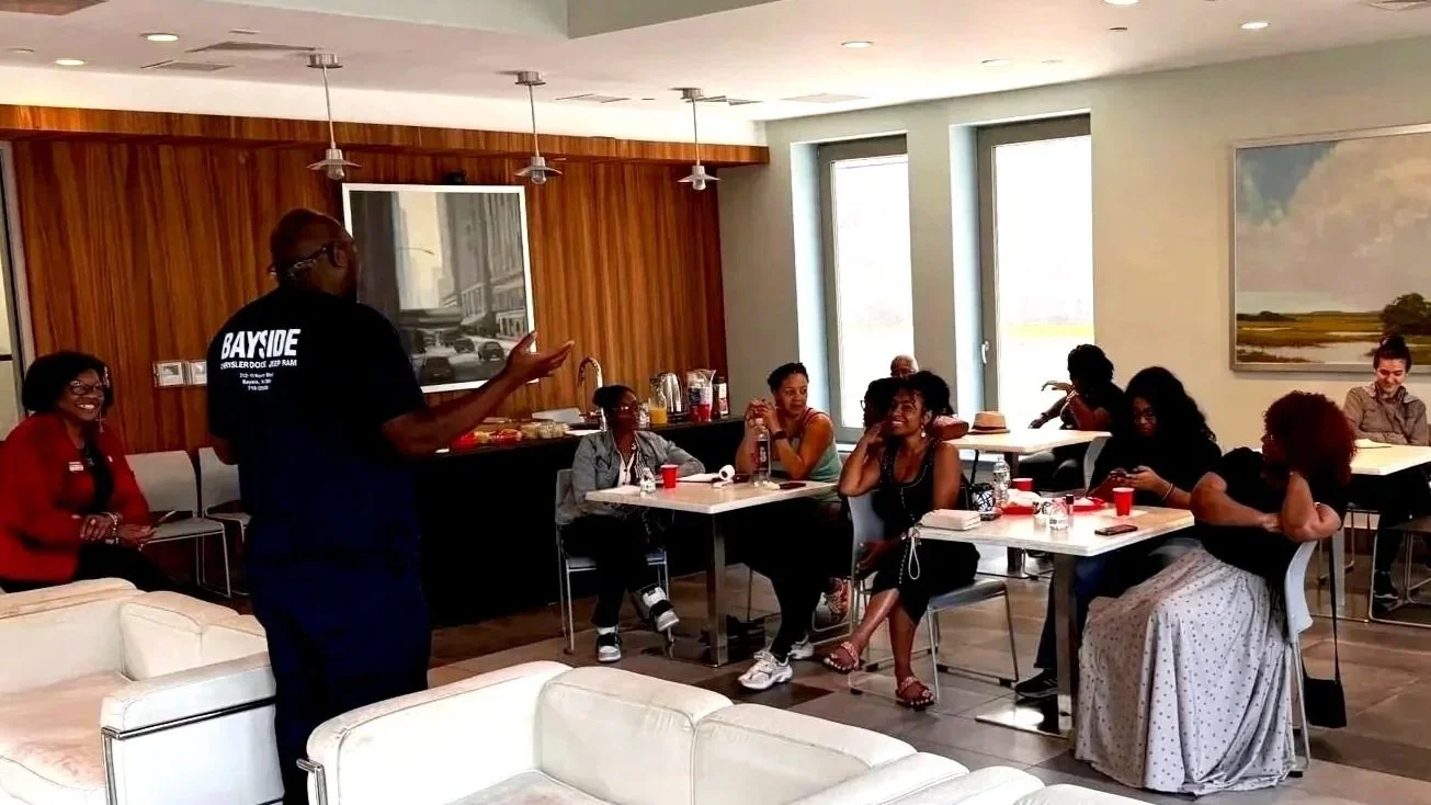 Women participating in a free automotive workshop supported by ColorsintheDark in NYC.