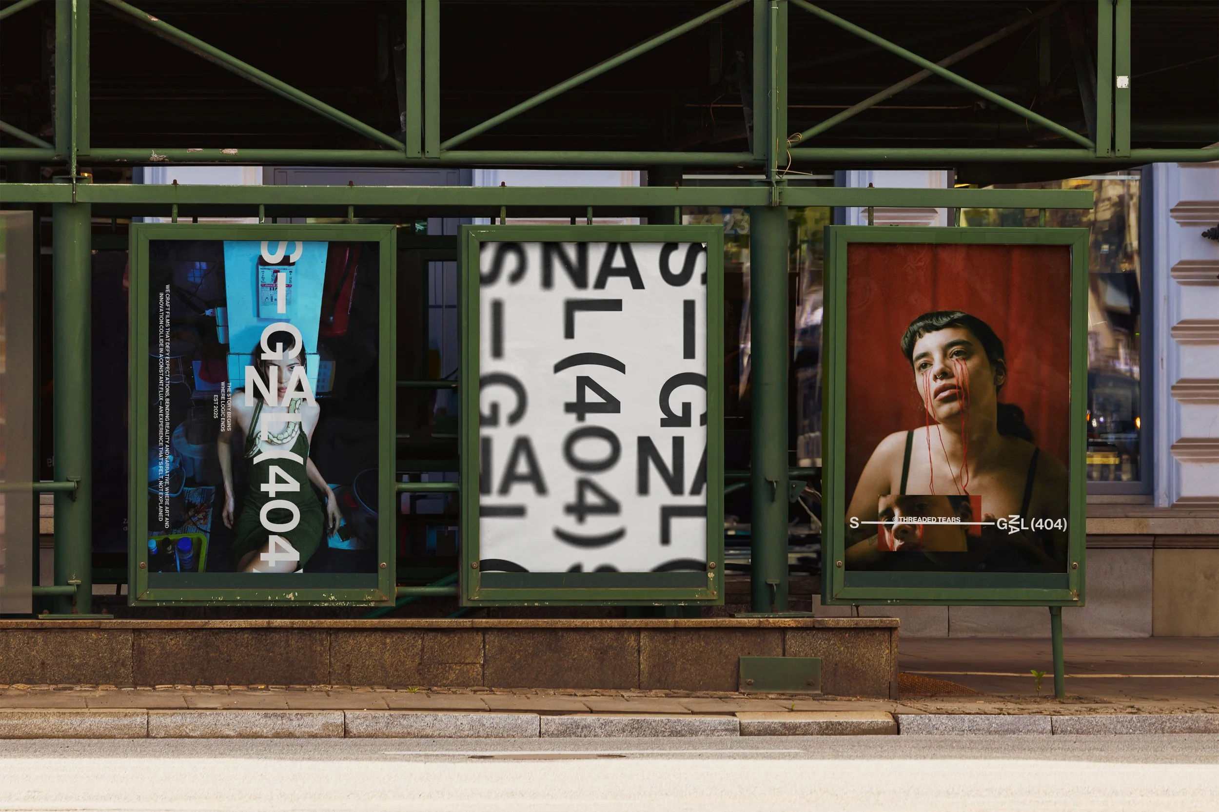 Mockup design of poster designs on a street. 3 poster designs for Signal 404 sit in metal frames