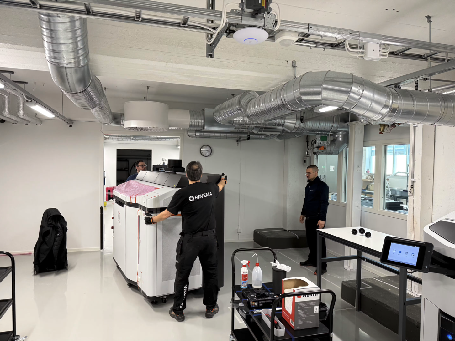 Technicians installing an HP Jet Fusion 5620 industrial 3D printer at Norra AM's additive manufacturing production facility in Sweden.