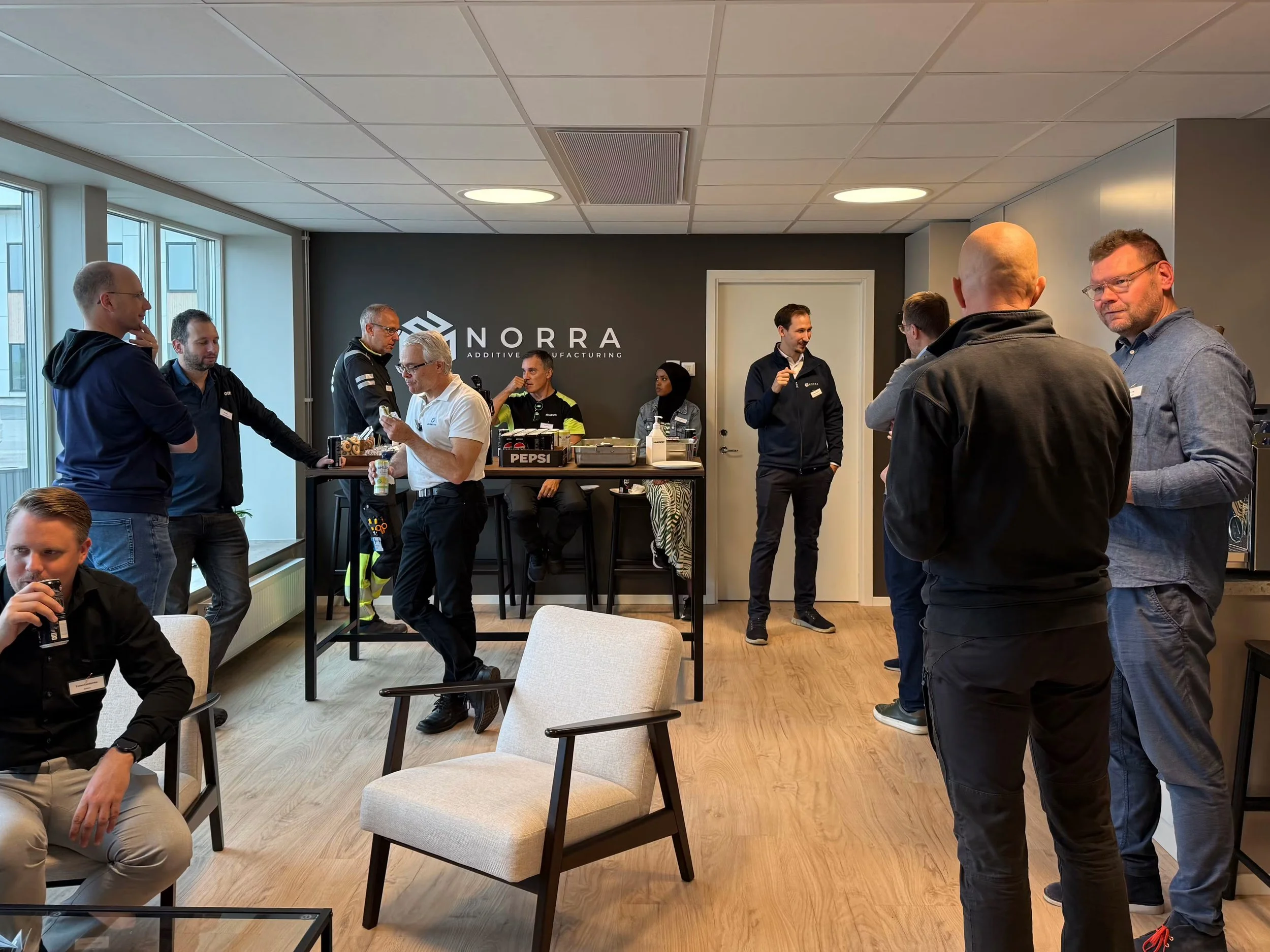 Attendees networking during a joint HP, Addinor, and Norra Additive Manufacturing event focused on industrial 3D printing and additive manufacturing.