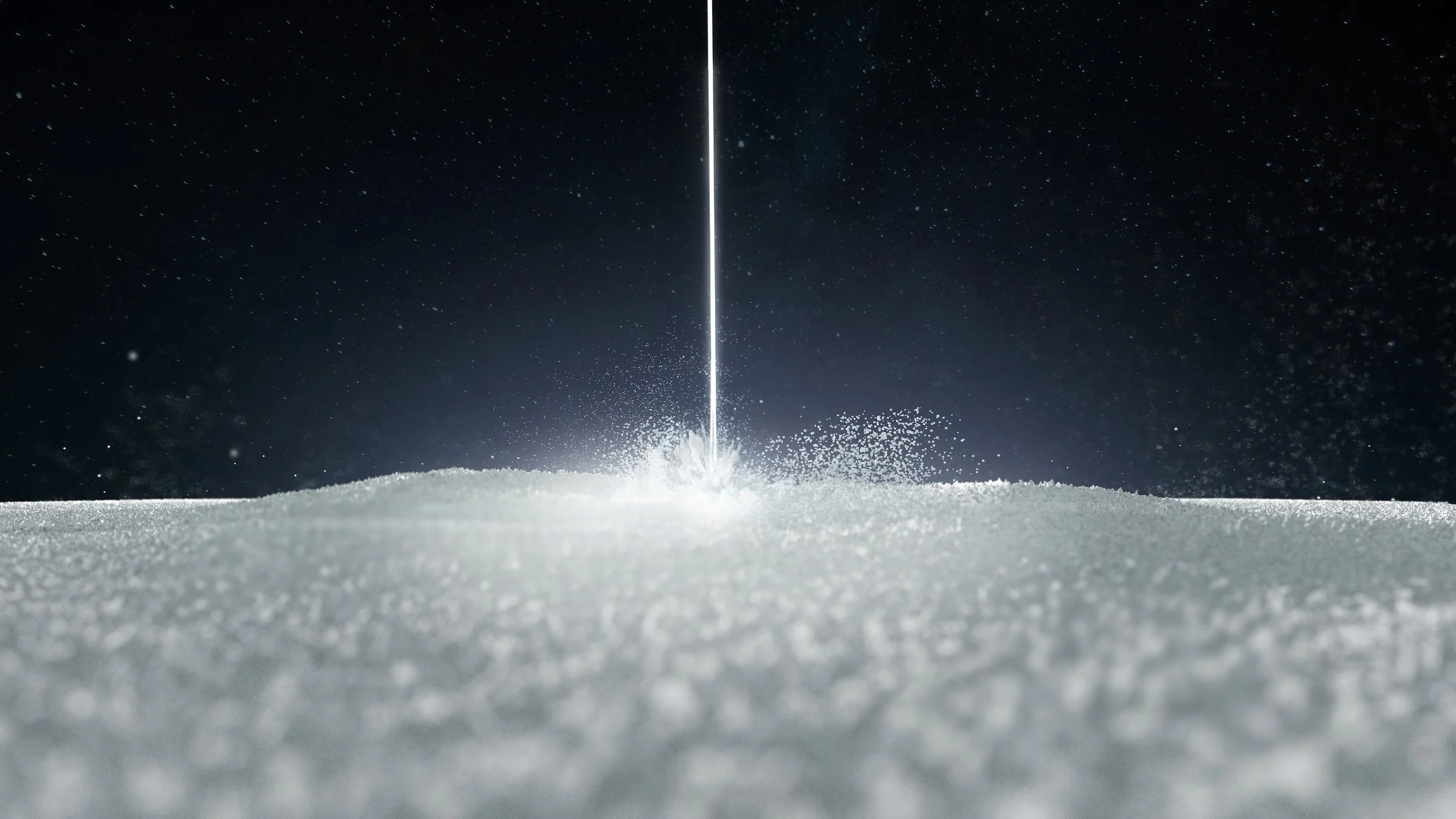 Laser beam sintering nylon powder inside an SLS 3D printer during the Selective Laser Sintering process.